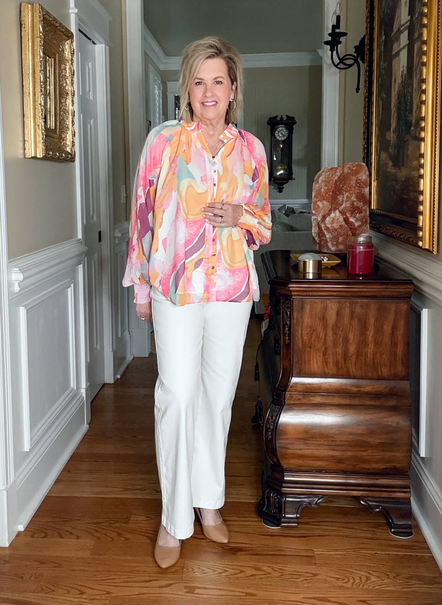 Tania Stephens is wearing a pair of white jeans and a lantern sleeve watercolor shirt from Amazon