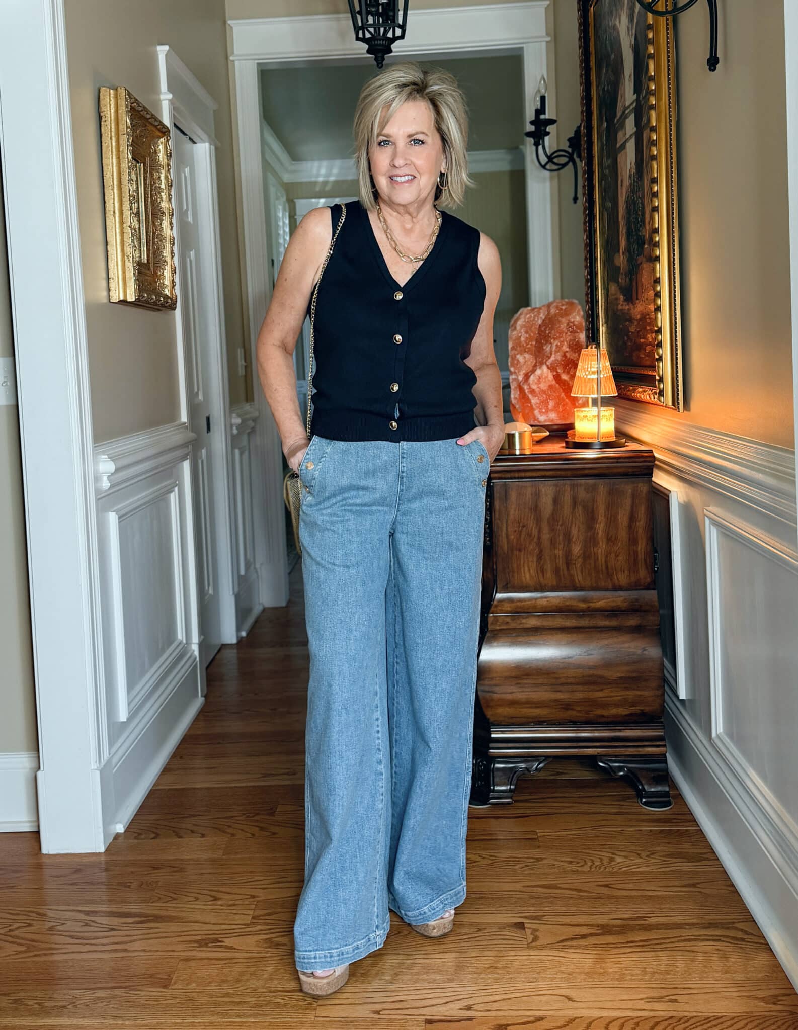 Tania Stephens is wearing a navy button vest and wide leg sailor jeans