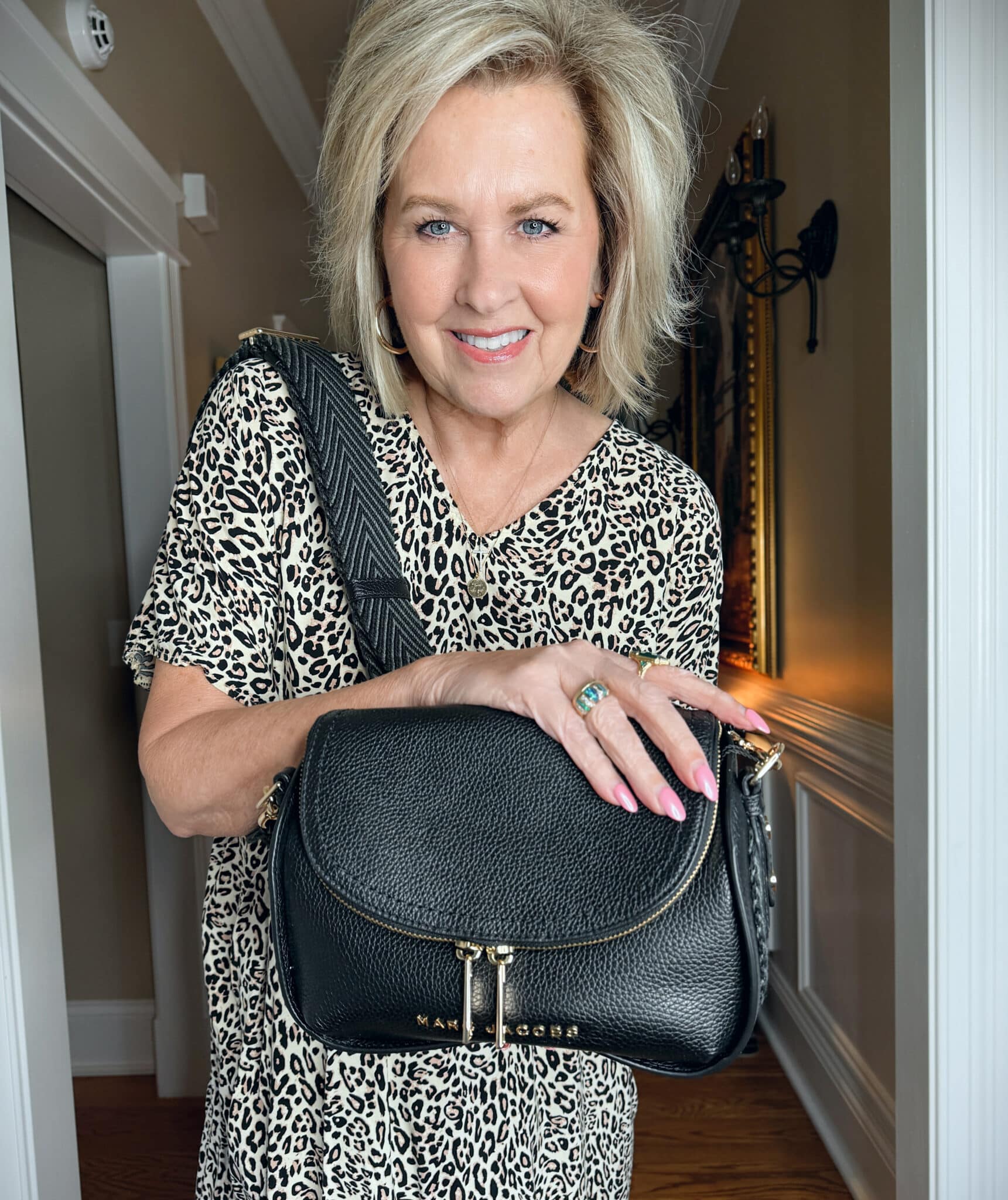 Tania Stephens wearing a leopard print caftan dress with a black handbag