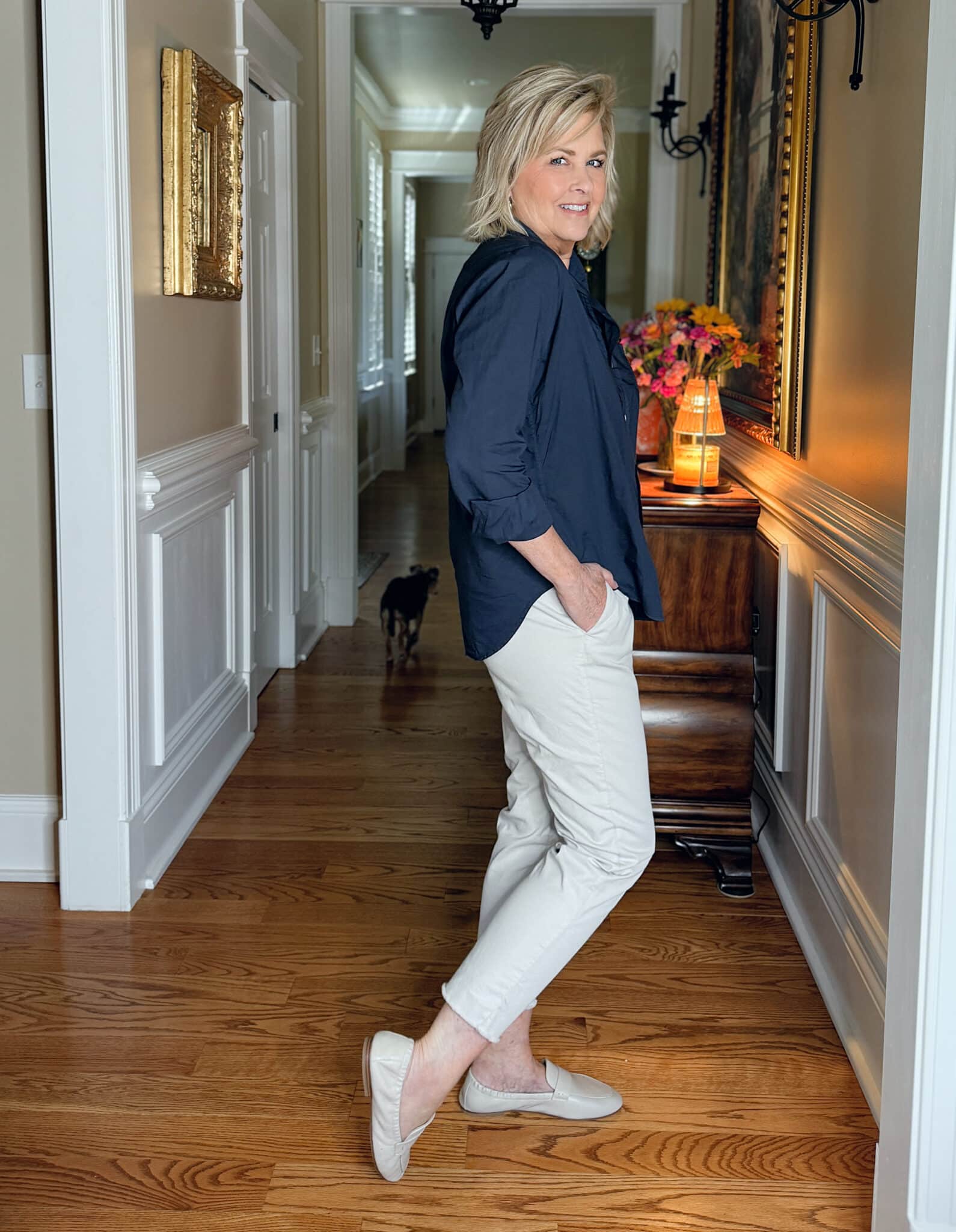 Tania Stephens showing the side view of a Frank & Eileen navy button up shirt and straight leg ankle pants