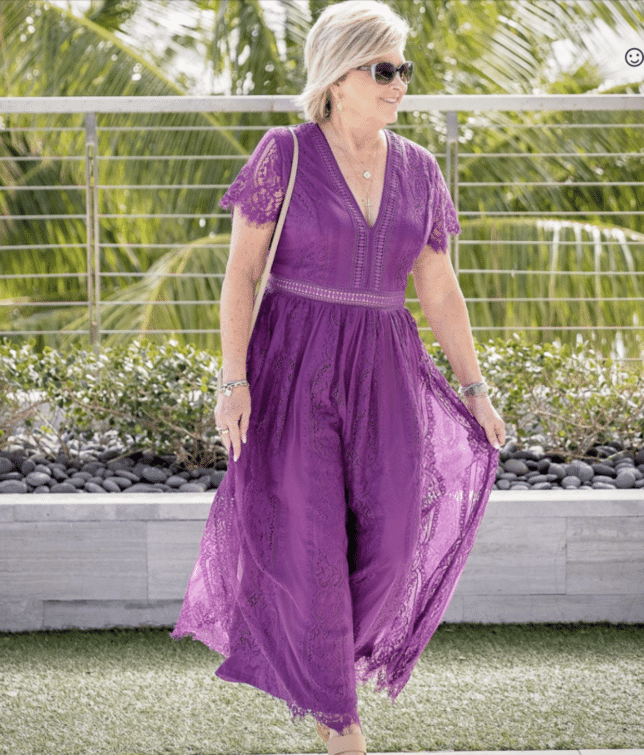 Tania wearing a purple lace maxi dress on vacation