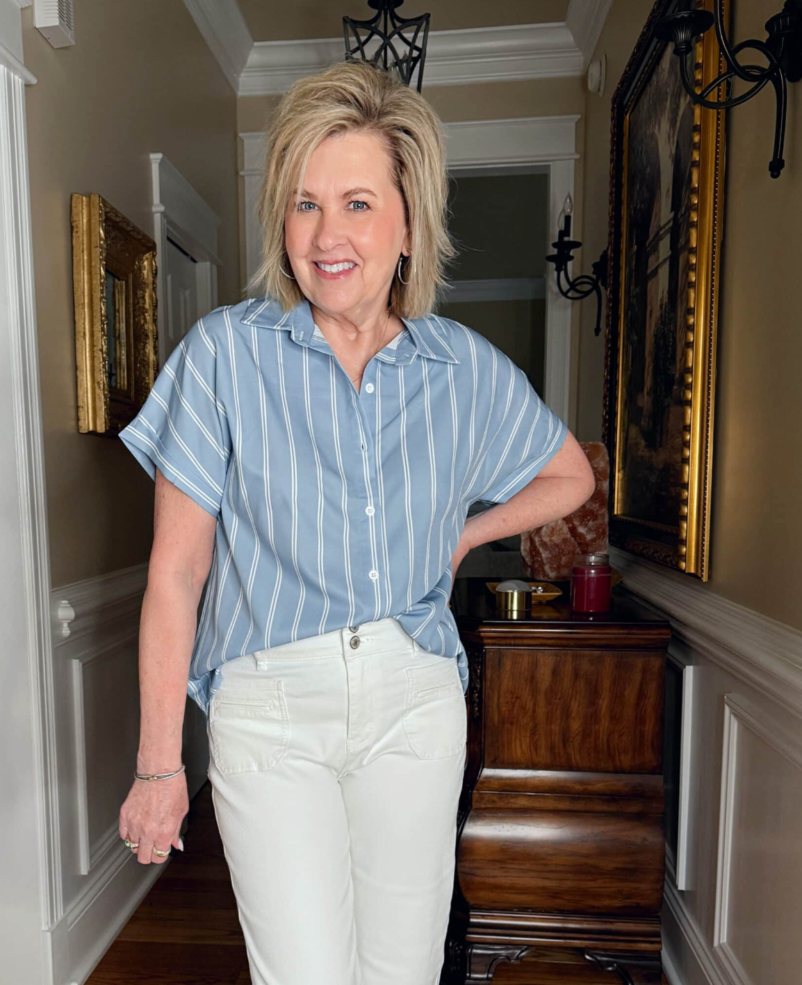 Tania Stephens is wearing a pair of white jeans and a tucked blue and white striped top from Amazon