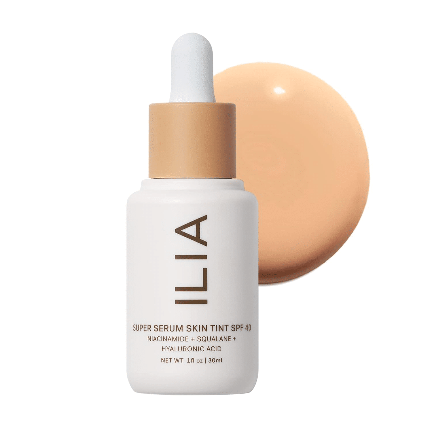 ILIA Super Serum Skin Tint SPF 40 bottle with dropper top, styled beside skincare. A skincare-meets-makeup tint that hydrates, protects, and brightens mature skin with sheer coverage.