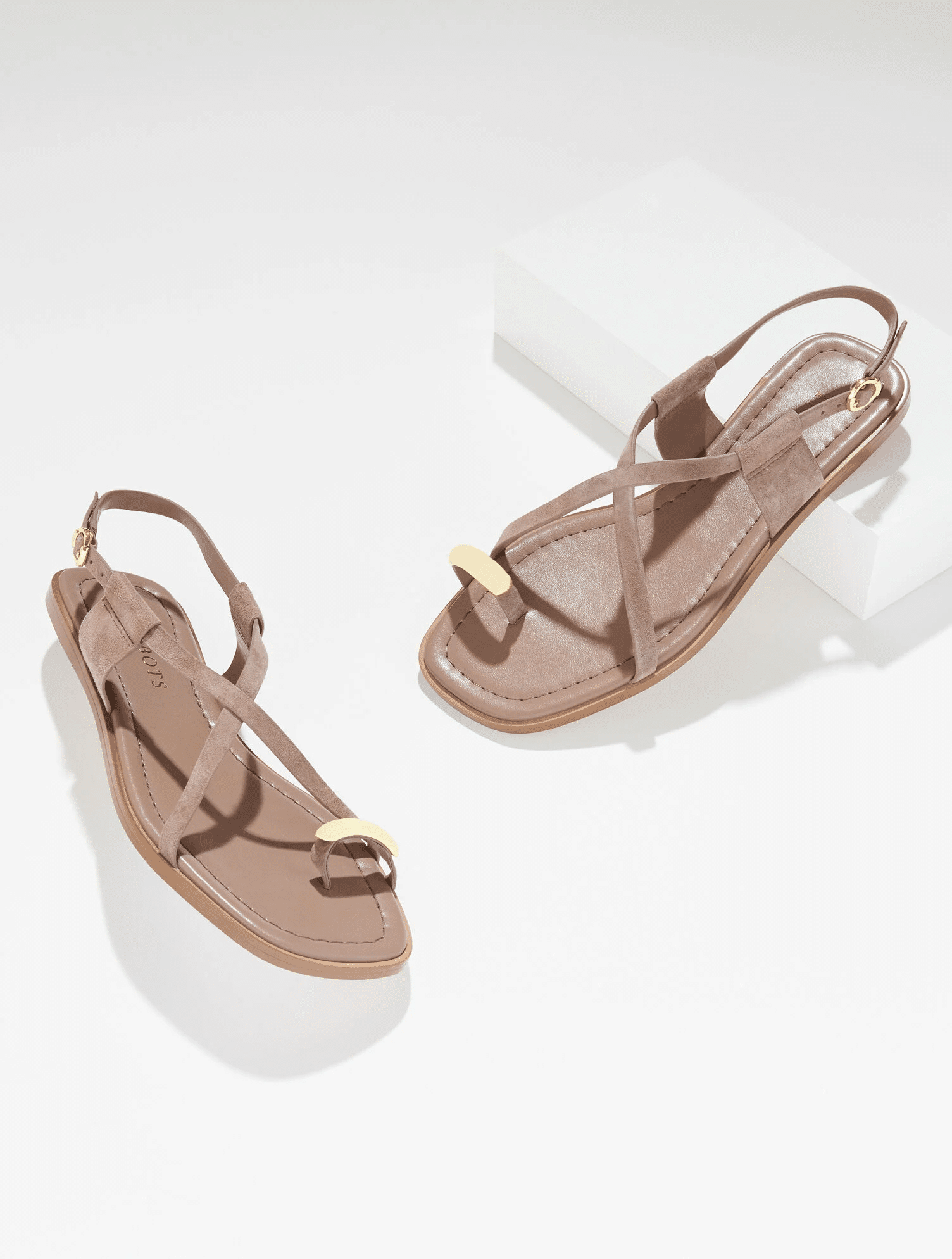 Tan suede sandal with gold accent.