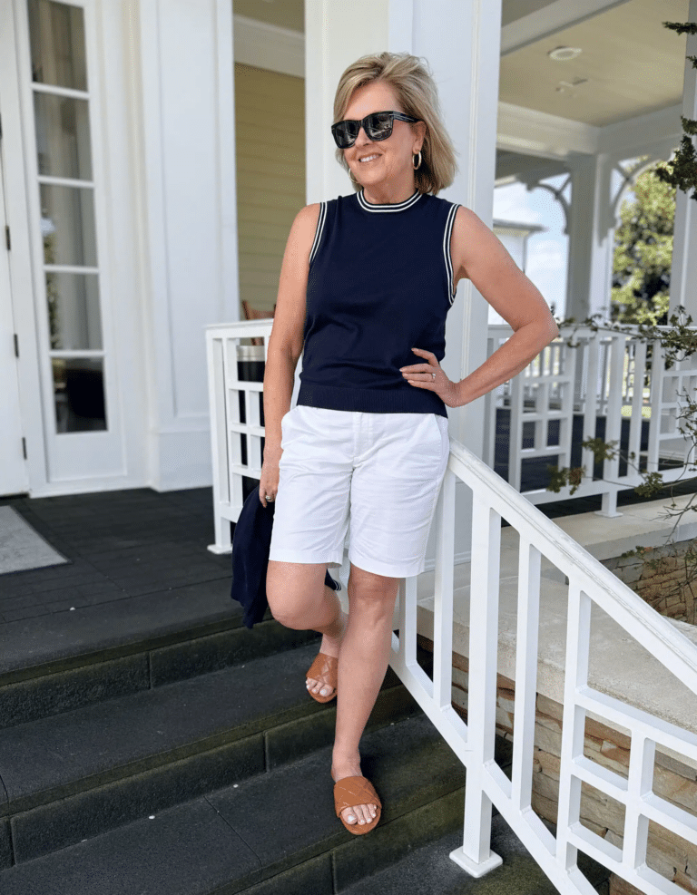 Tania wearing a navy tank and white 9" shorts