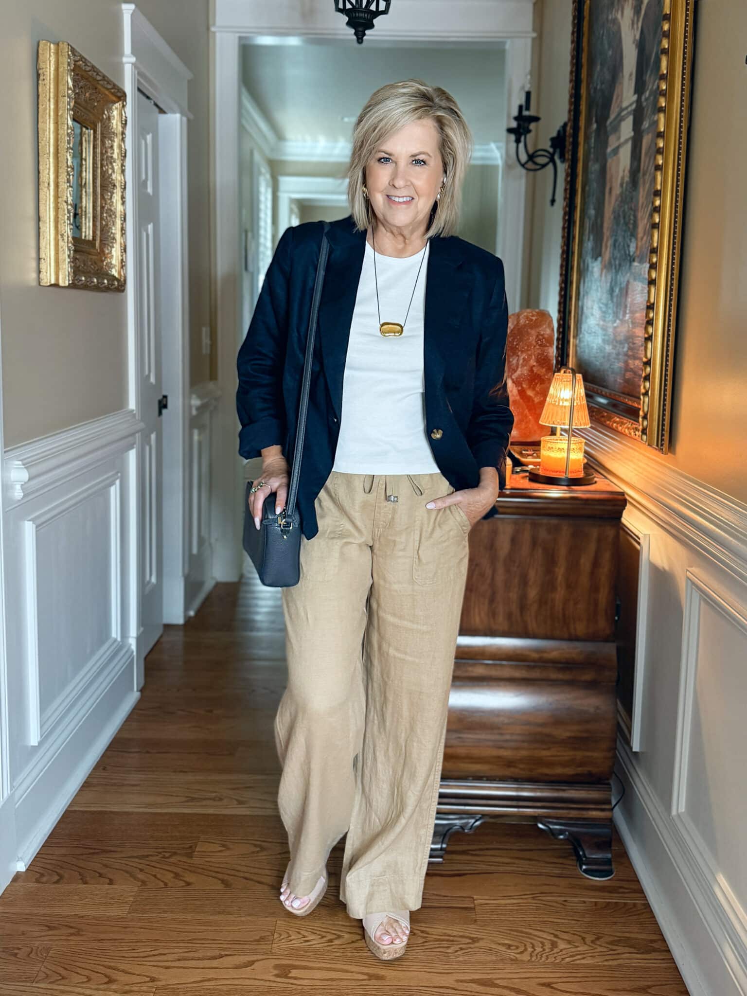 woman wearing a navy blazer with a white tee and linen pants from Macy's