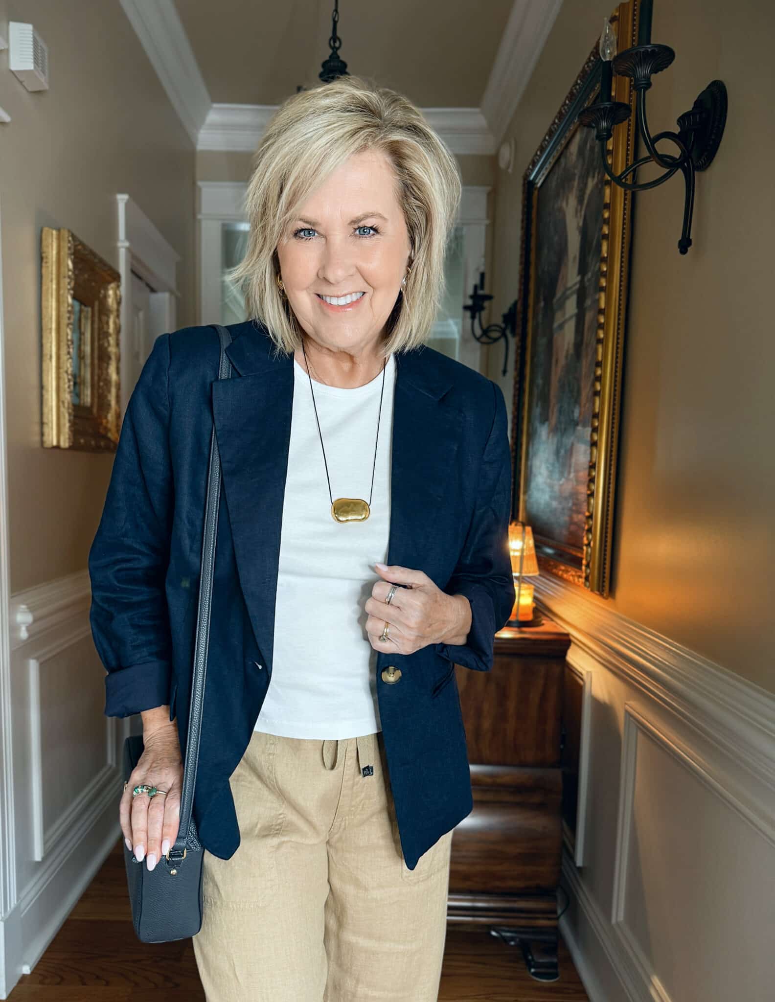 woman wearing a navy blazer with a white tee 