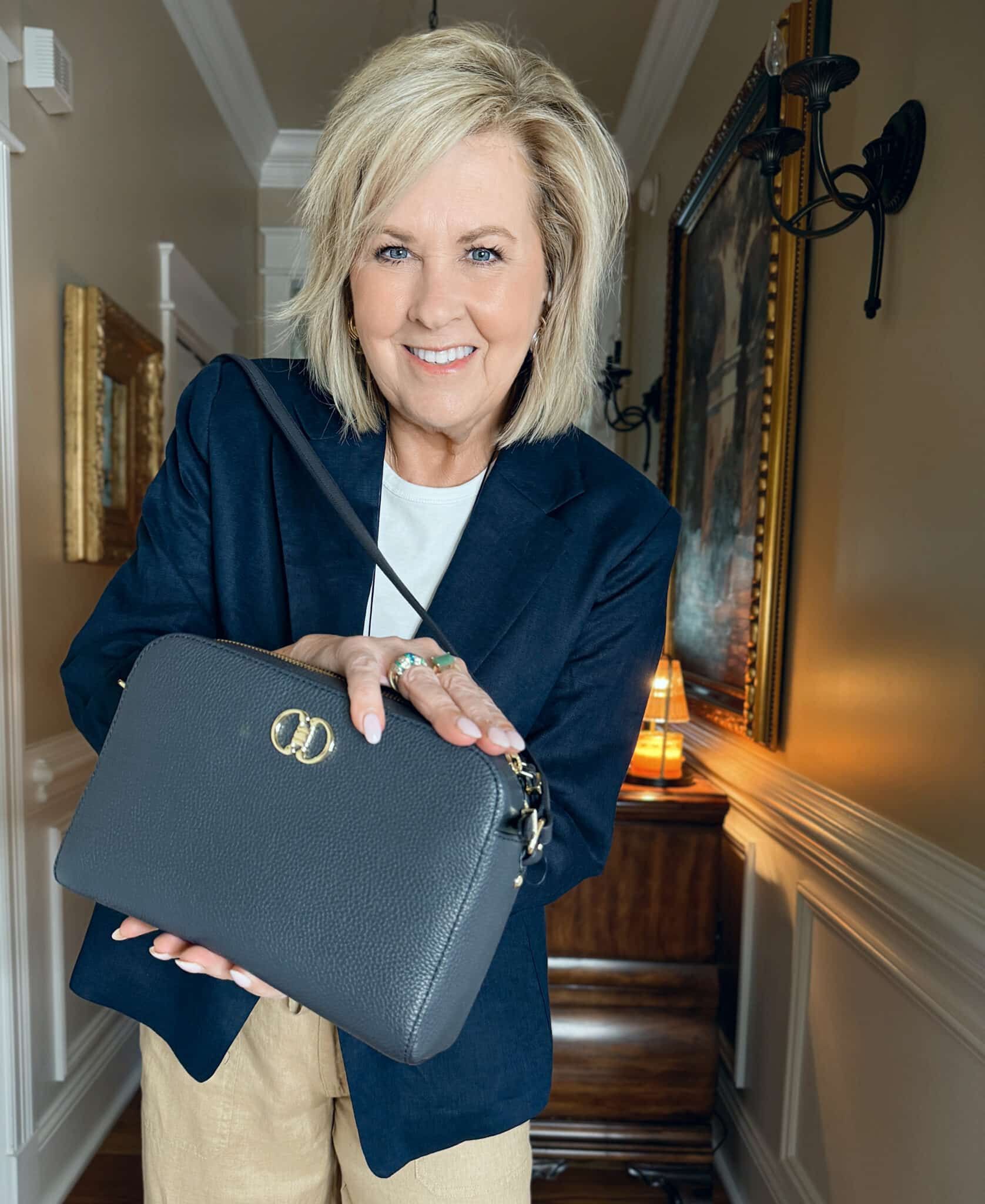 woman wearing a navy blazer with a navy handbag