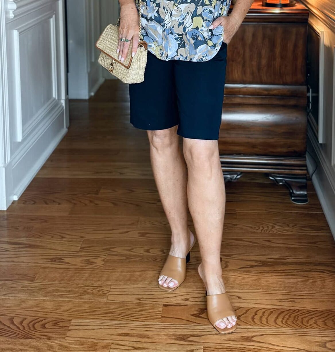 woman wearing navy Bermuda shorts
