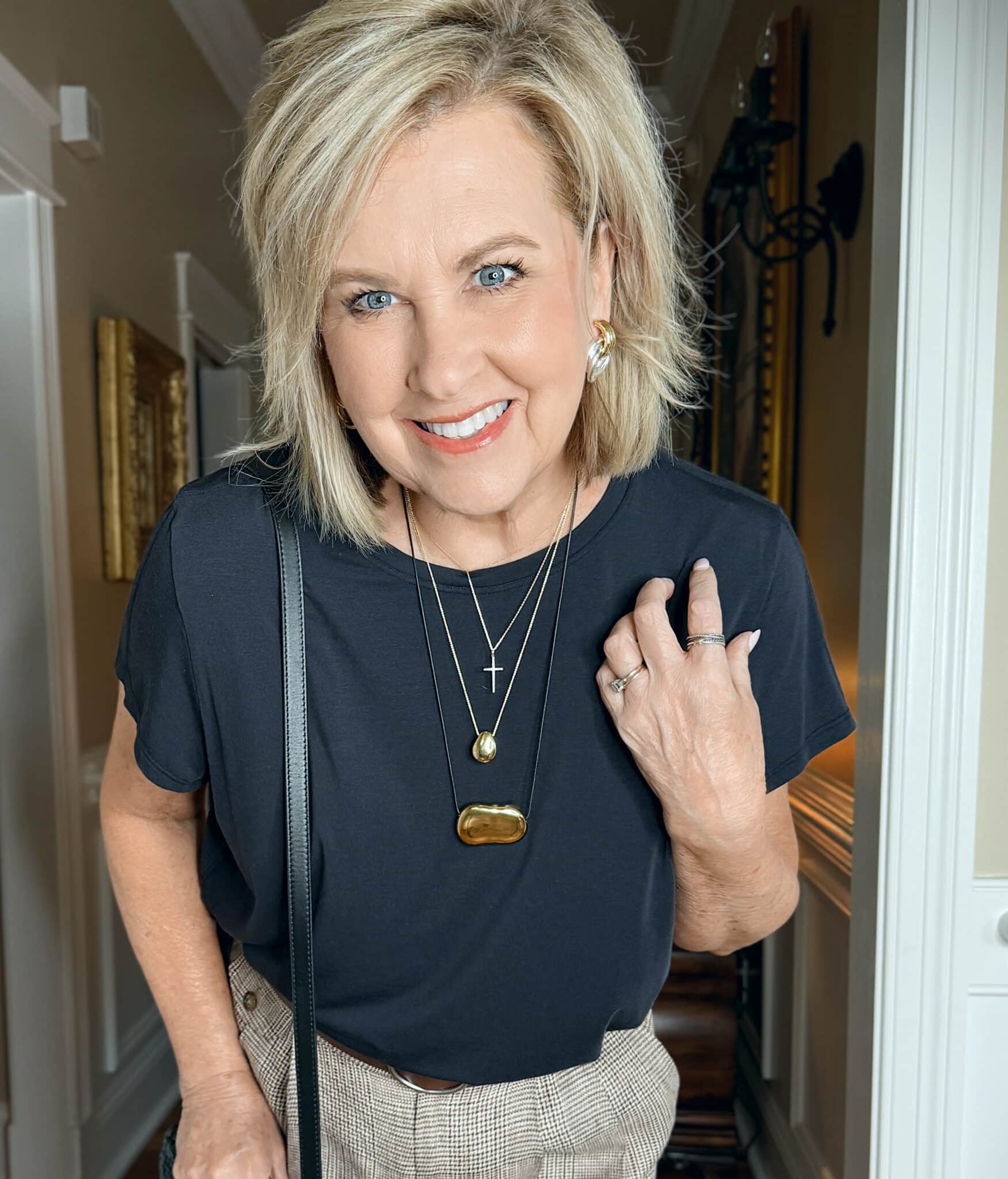 woman wearing a black top and gold jewelry