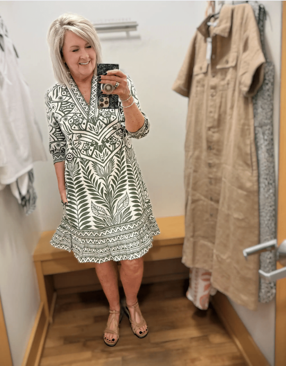 Tania wearing a green and white printed V-neck dress from Chico's