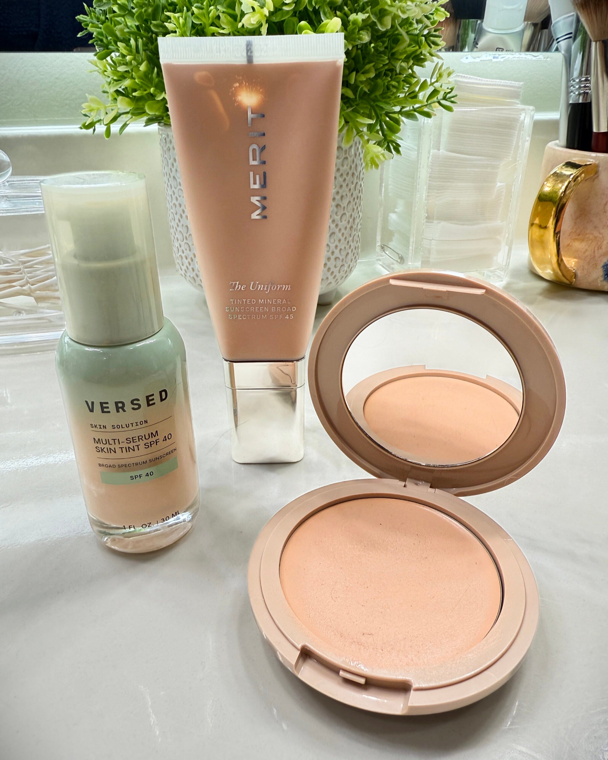 Group photo of three lightweight foundations for mature skin: Merit Beauty’s Tinted Mineral Sunscreen, Versed Skin Tint Foundation, and No Makeup Makeup Foundation in Almond. A trio of everyday favorites that offer sheer, breathable coverage with added skincare benefits and sun protection.
