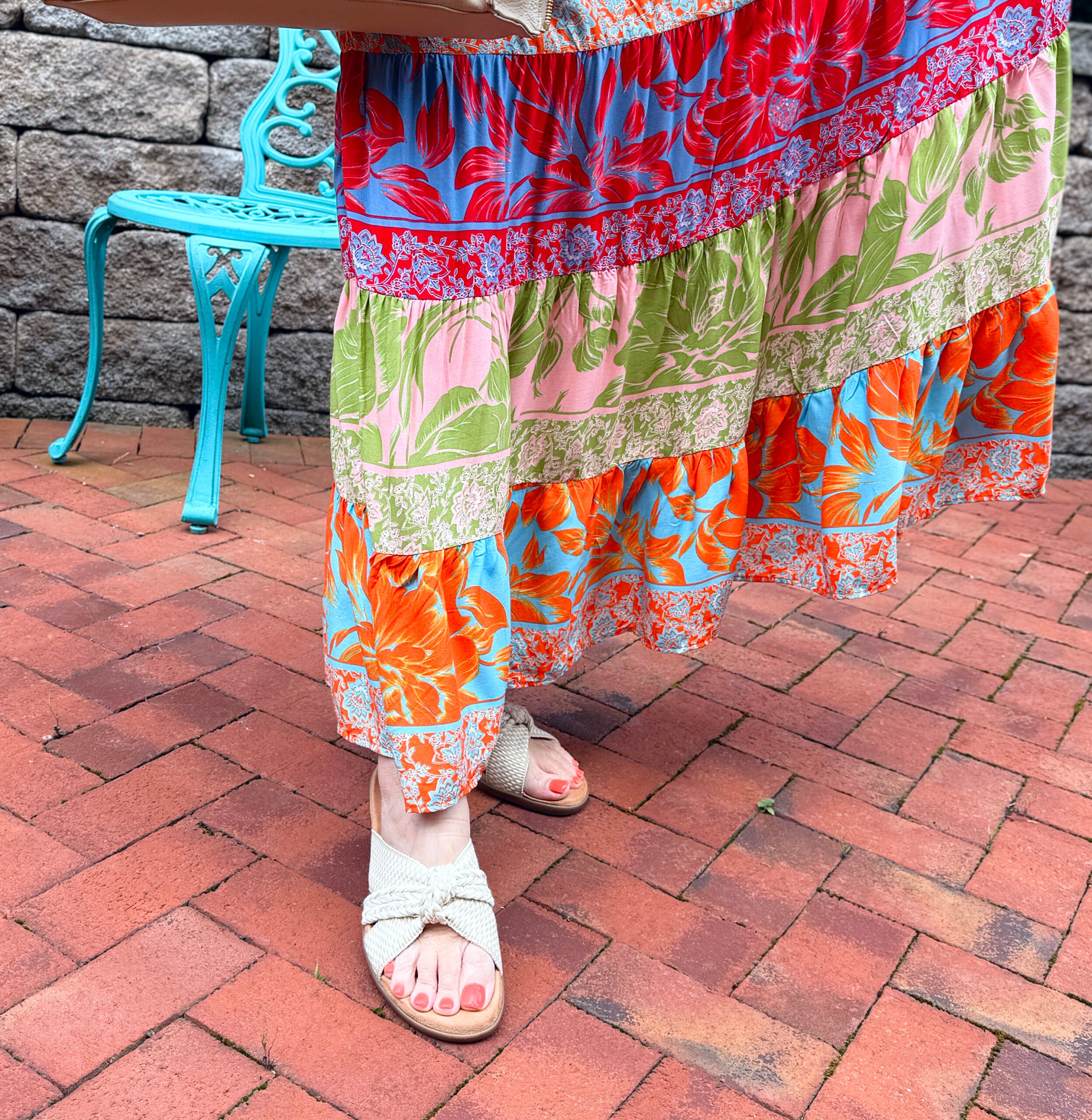 woman wearing sandals with a colorful maxi dress 
