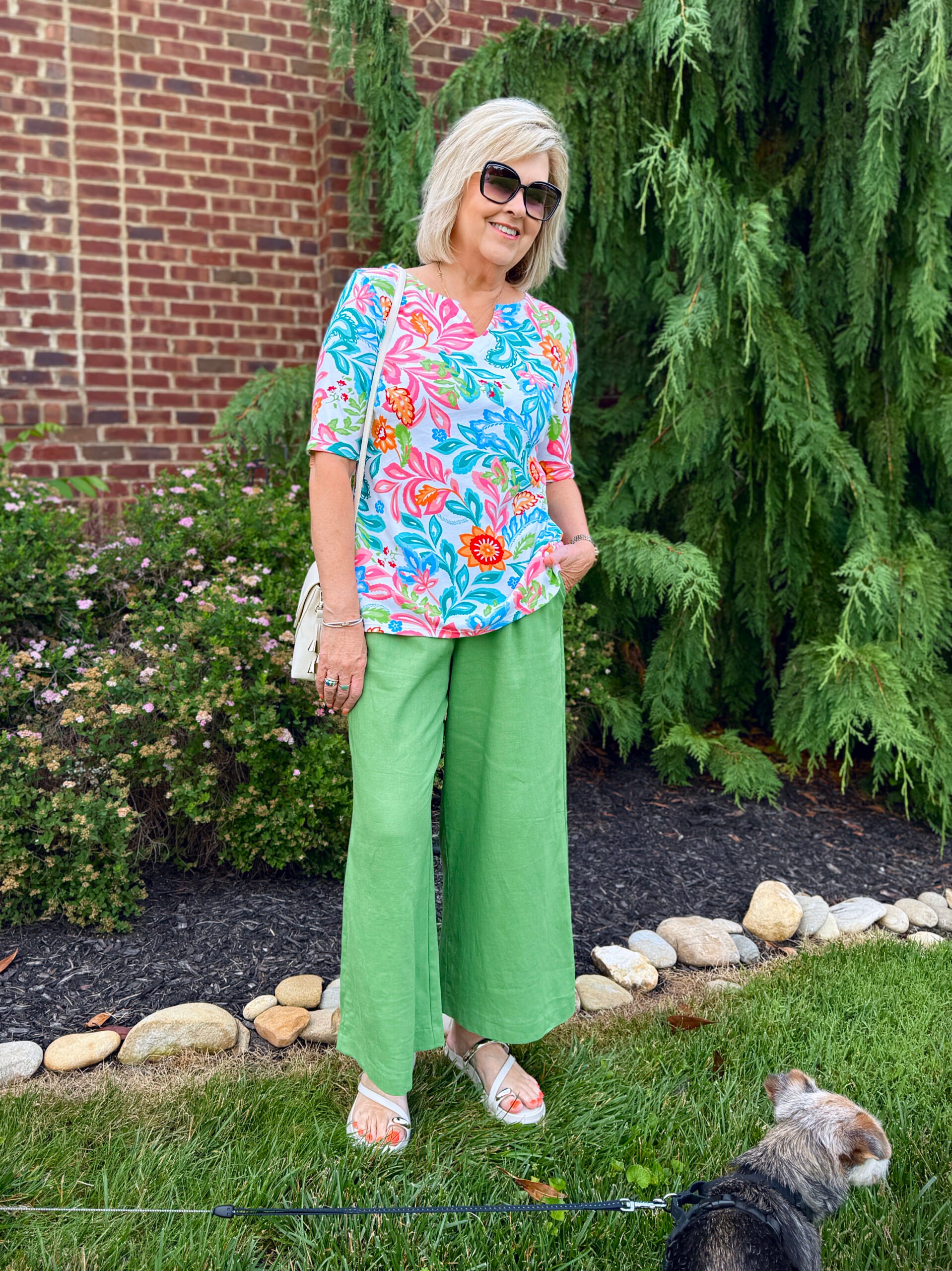 Tania Stephens wearing green pants with a colorful printed top