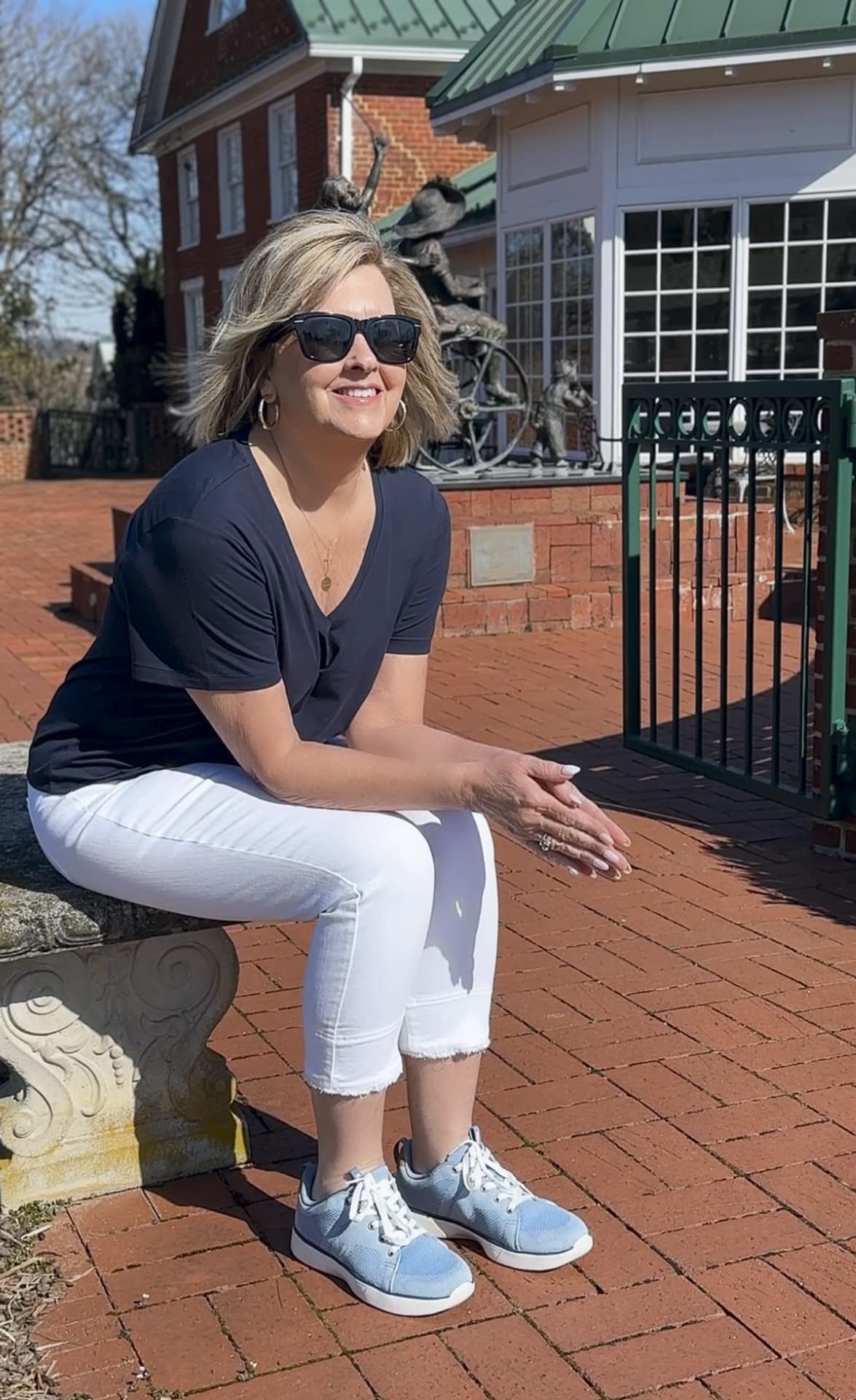 Tania pairing white fringe crop jeans with lace-up Keds sneakers and a navy V-neck tee for a casual day out