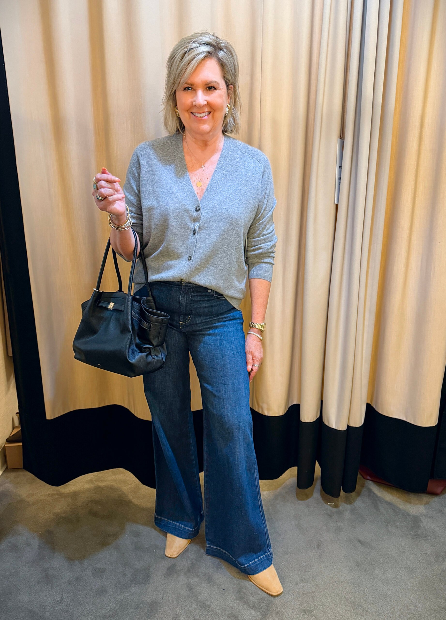 Tania wearing Frame wide-leg jeans and a cashmere cardigan with Steve Madden mules and a brown tote bag, styled for fall.