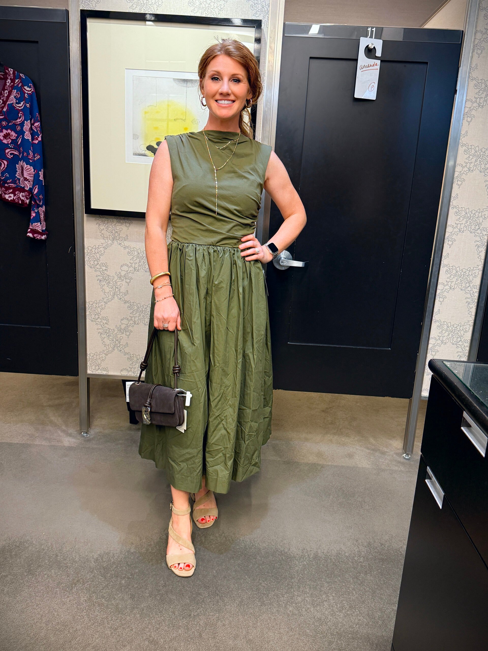 Stephanie wearing a green wide neck dress