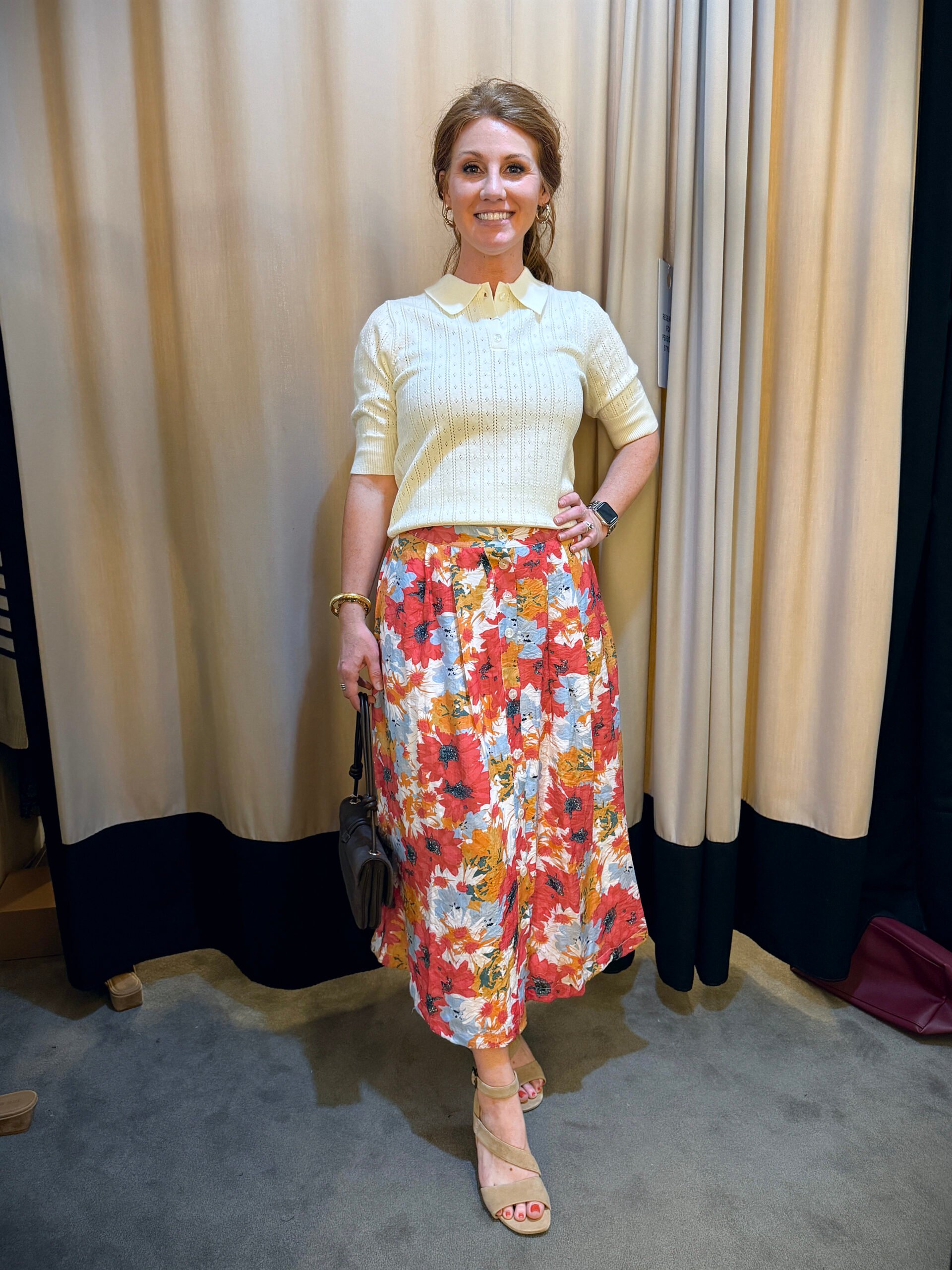 Stephanie wearing a short sleeve sweater and a floral skirt - a great fall transition outfit to wear now