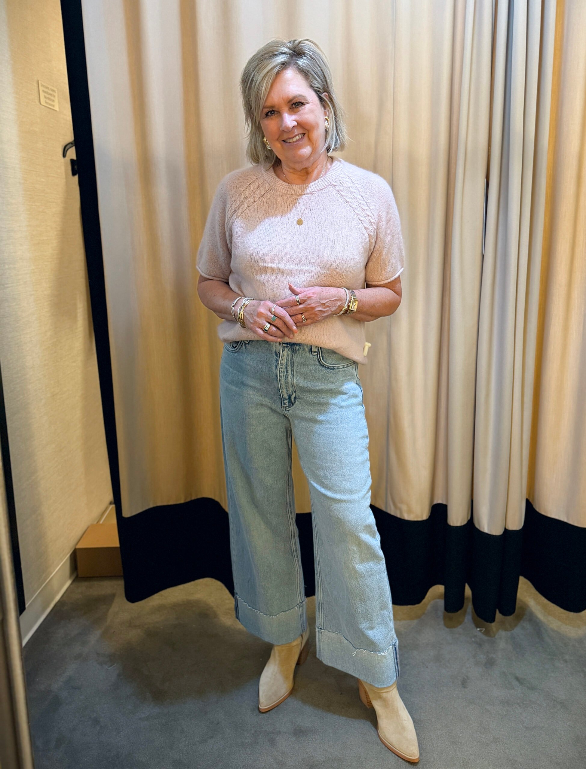 Tania wearing a pale pink sweater with jeans - a great fall transition outfit to wear now