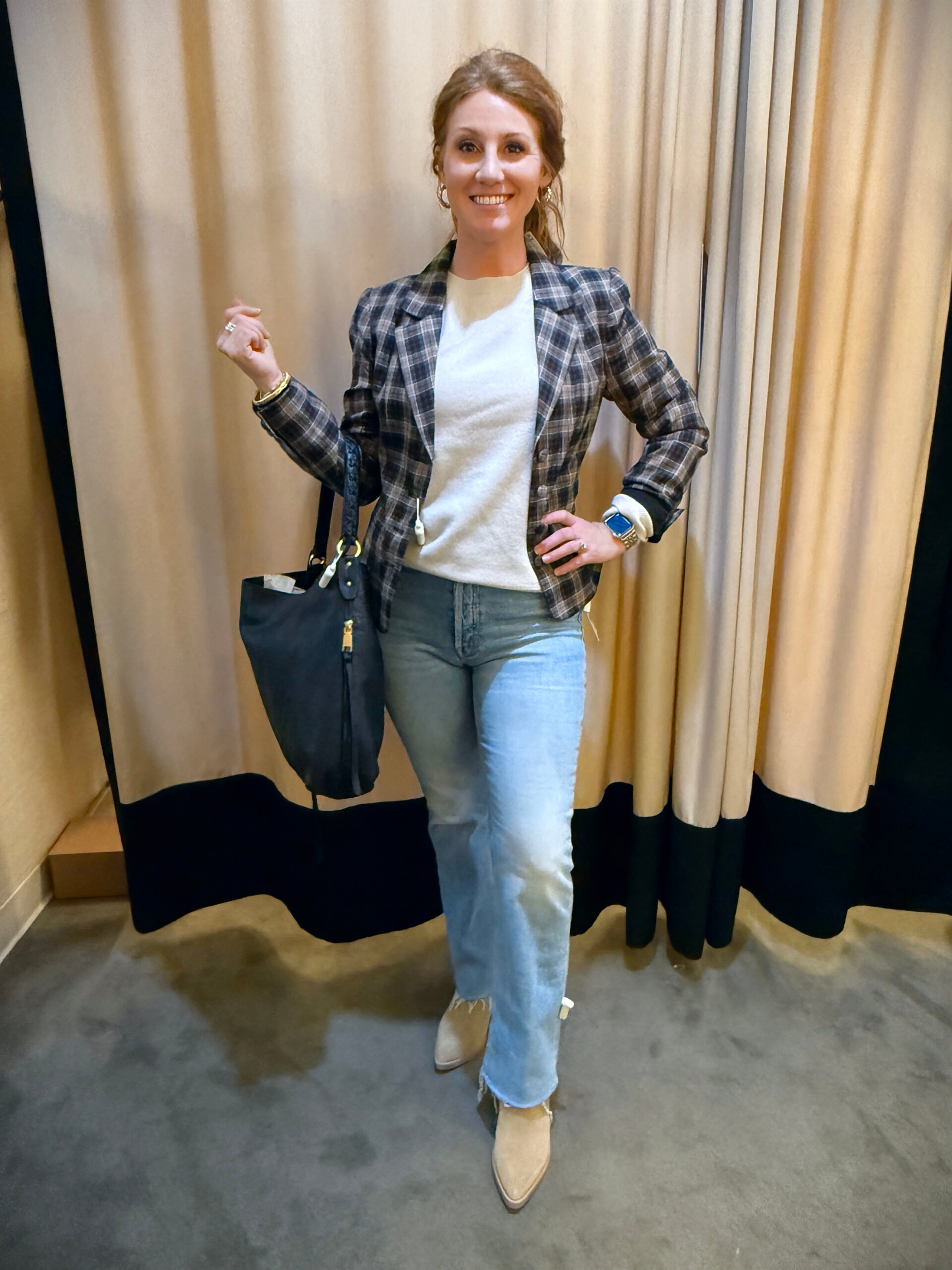 Stephanie wearing a plaid blazer with a white tee and jeans