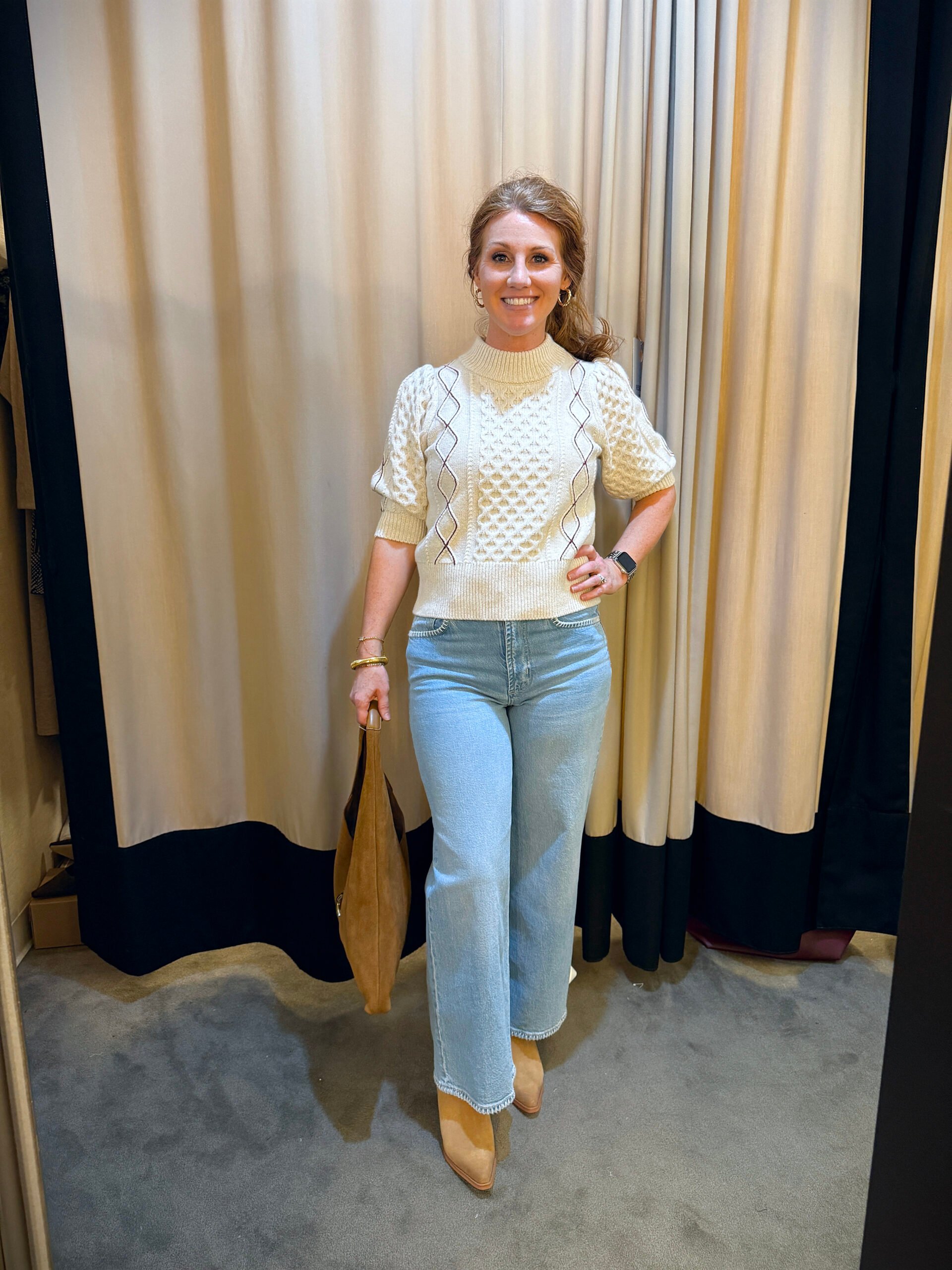 Stephanie wearing a short sleeve sweater and jeans - a great fall transition outfit to wear now