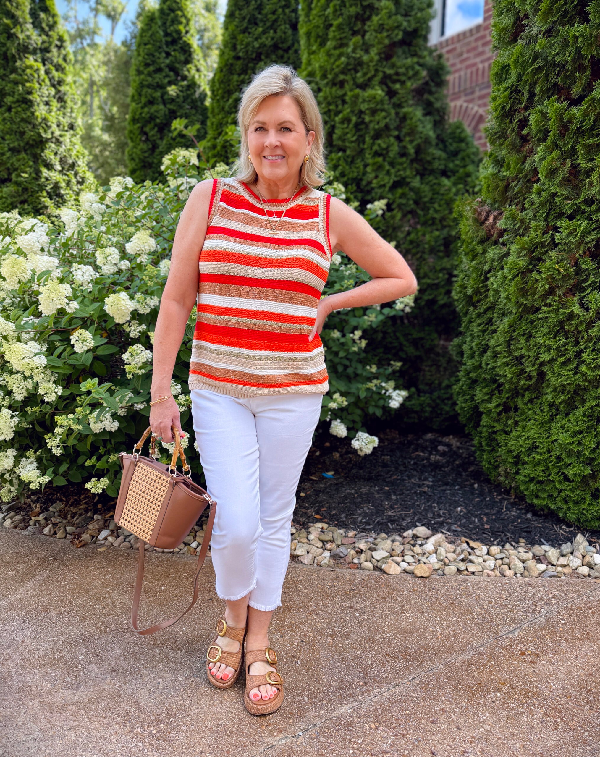 Tania wearing a striped summer tank sweater from Chico's with white crop jeans