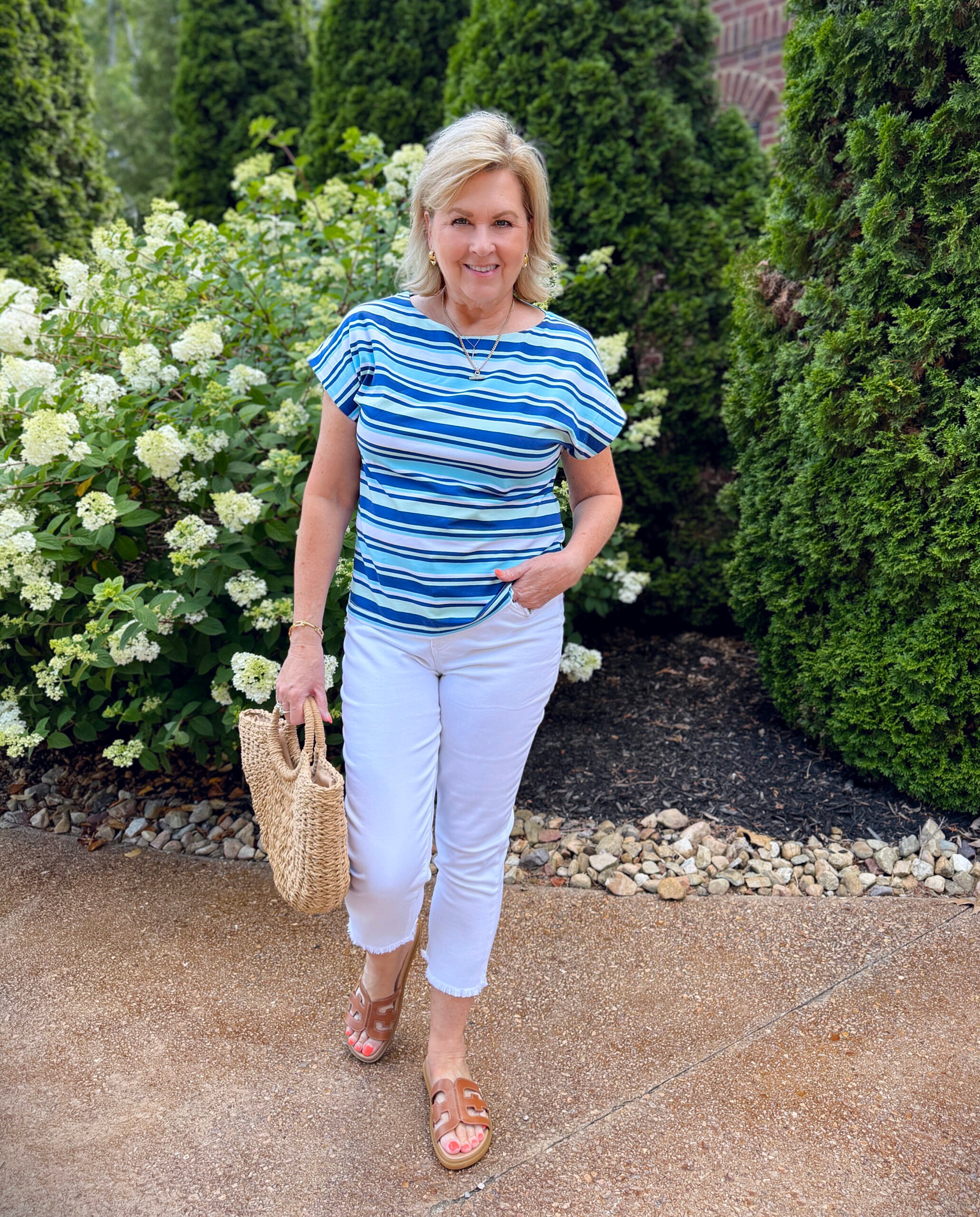 Tania wearing a striped summer tee from Chico's with white crop jeans