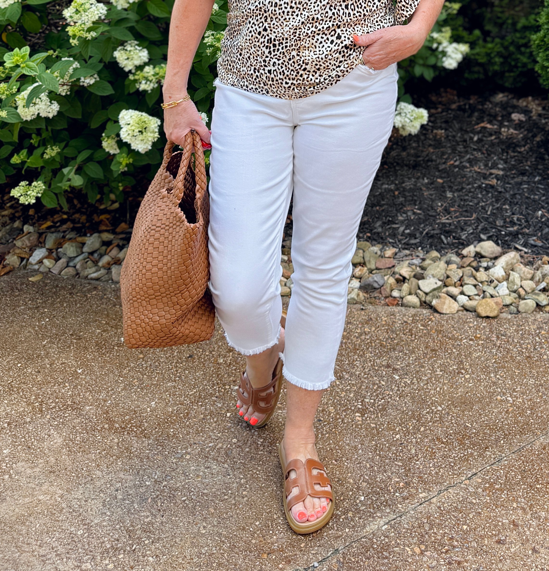 Tania wearing white crop jeans with sandals