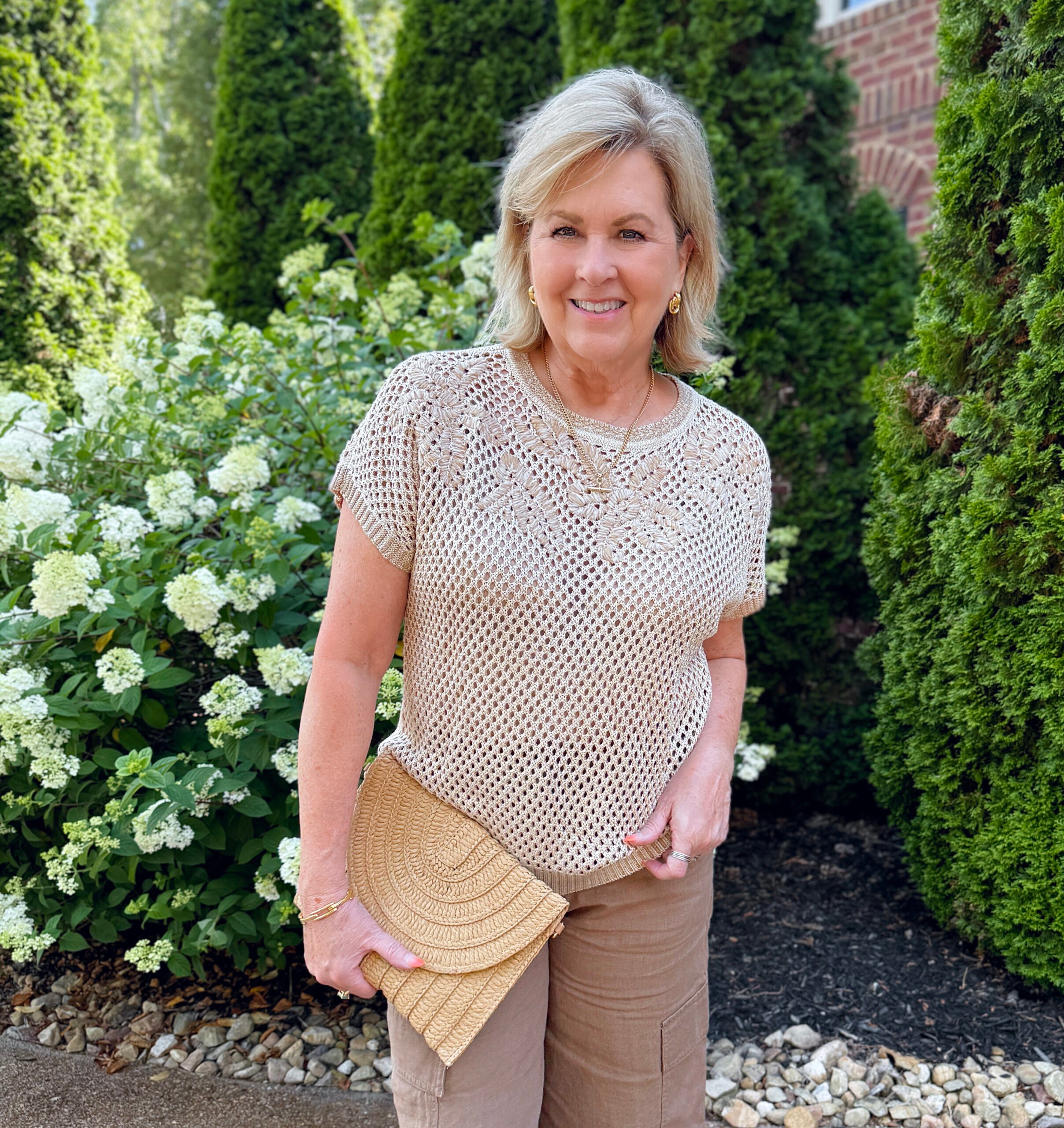 Tania wearing a open knit top from Chico's 