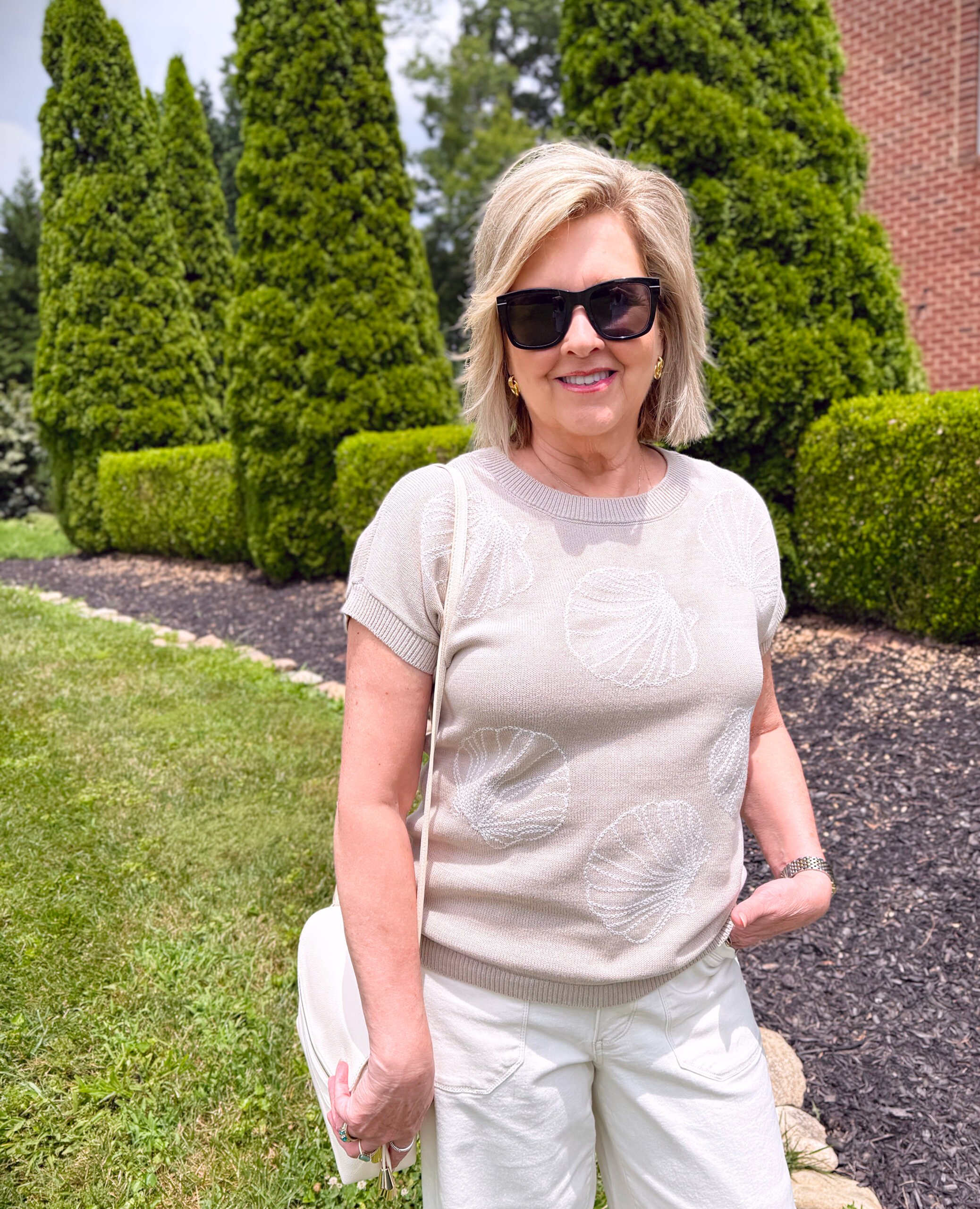 Tania Stephens wearing a neutral sweater with a shell design from Kohls