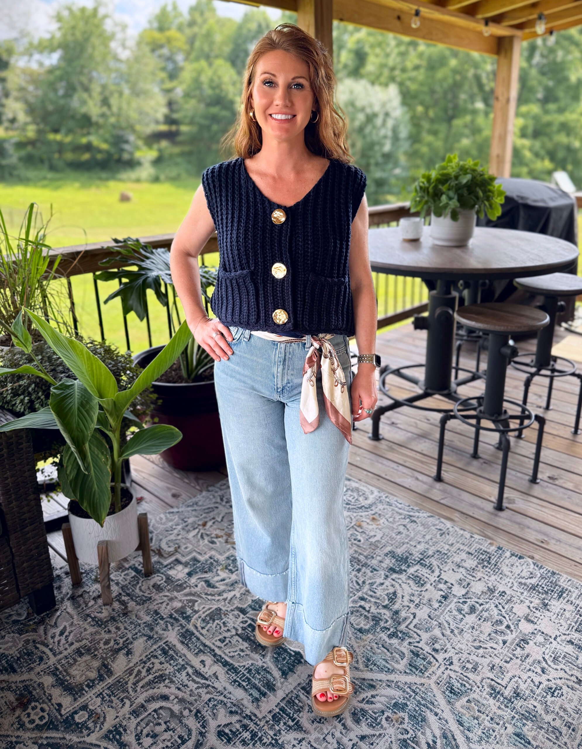 Stephanie, a petite 5'3" tall, wearing a navy chunky knit vest from Amazon with jeans