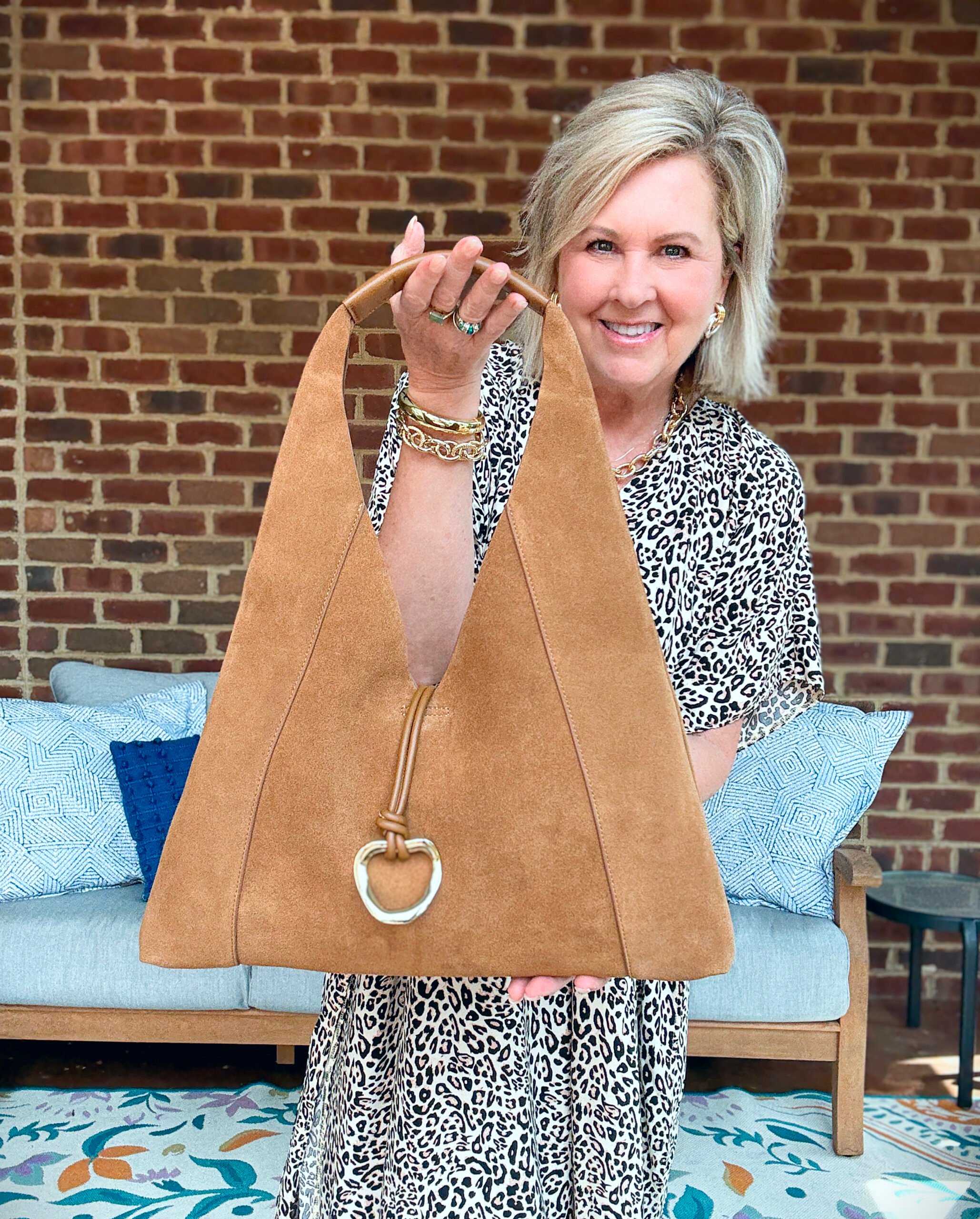 Tania Stephens showing her hobo styled shoulder bag by Dolce Vita