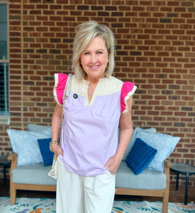 ania wearing a brightly colored flutter sleeve top