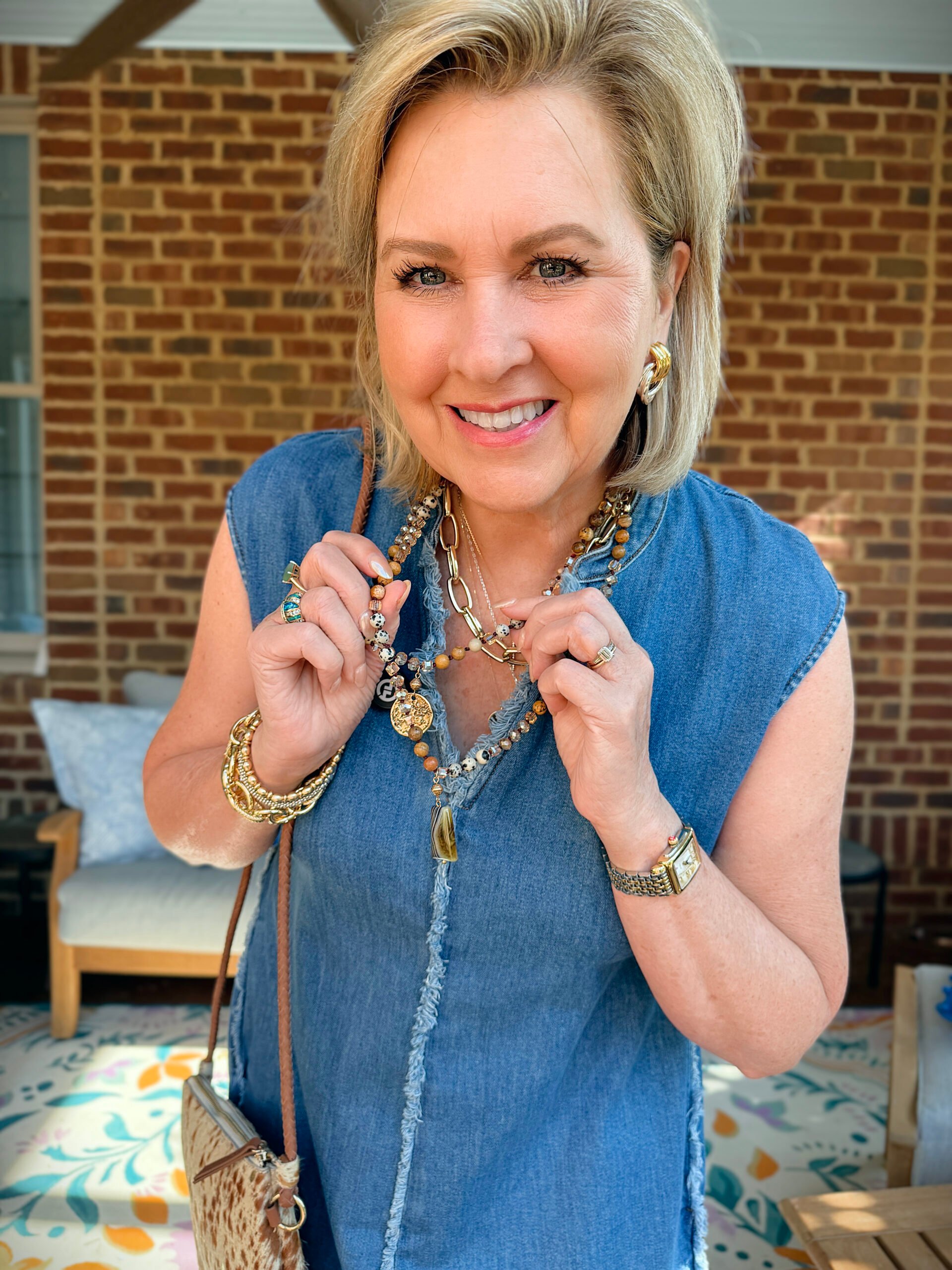 Tania is wearing a jewelry with a frayed denim dress