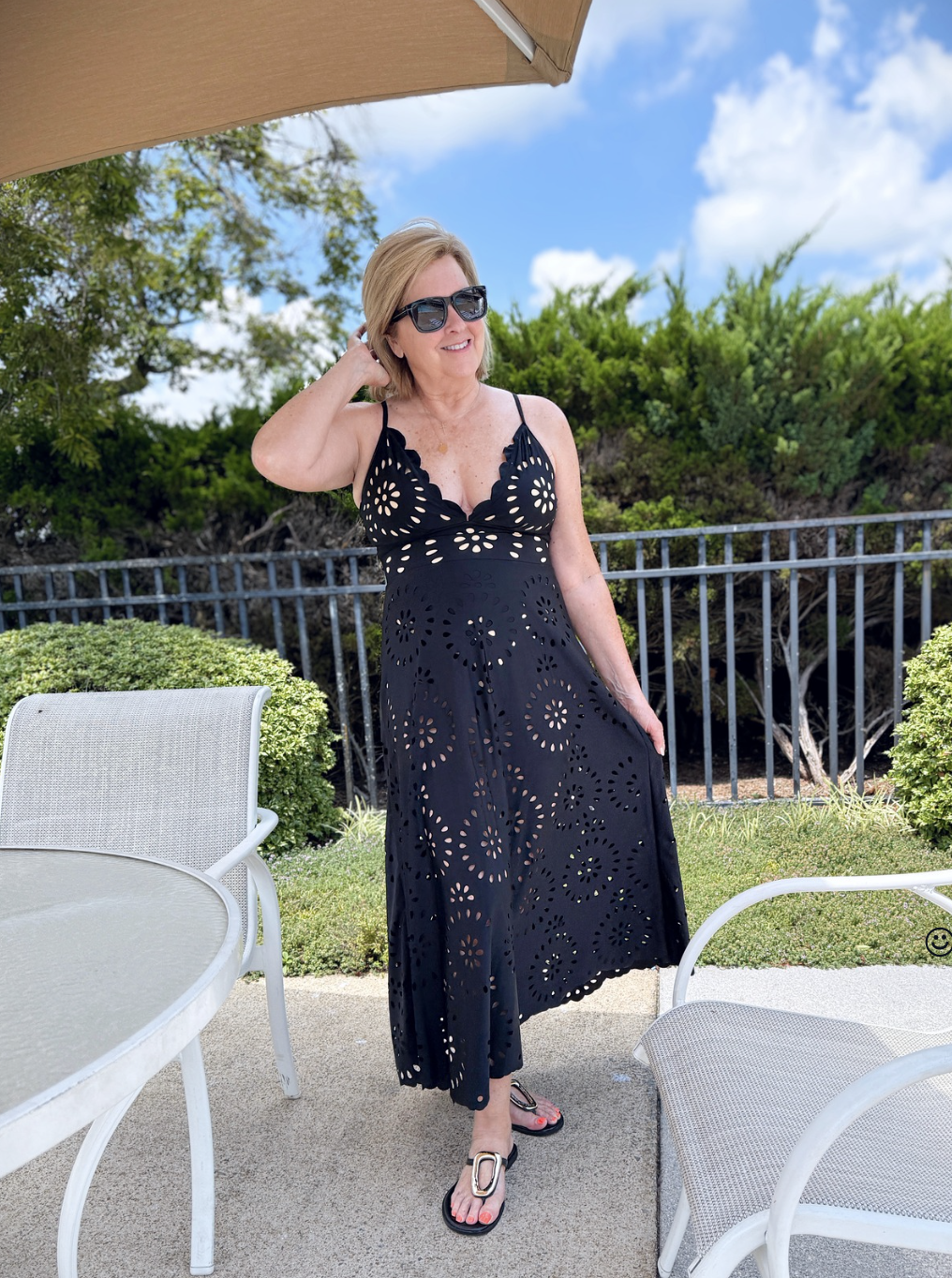 Tania Stephens at the pool in a black swimsuit and coverup