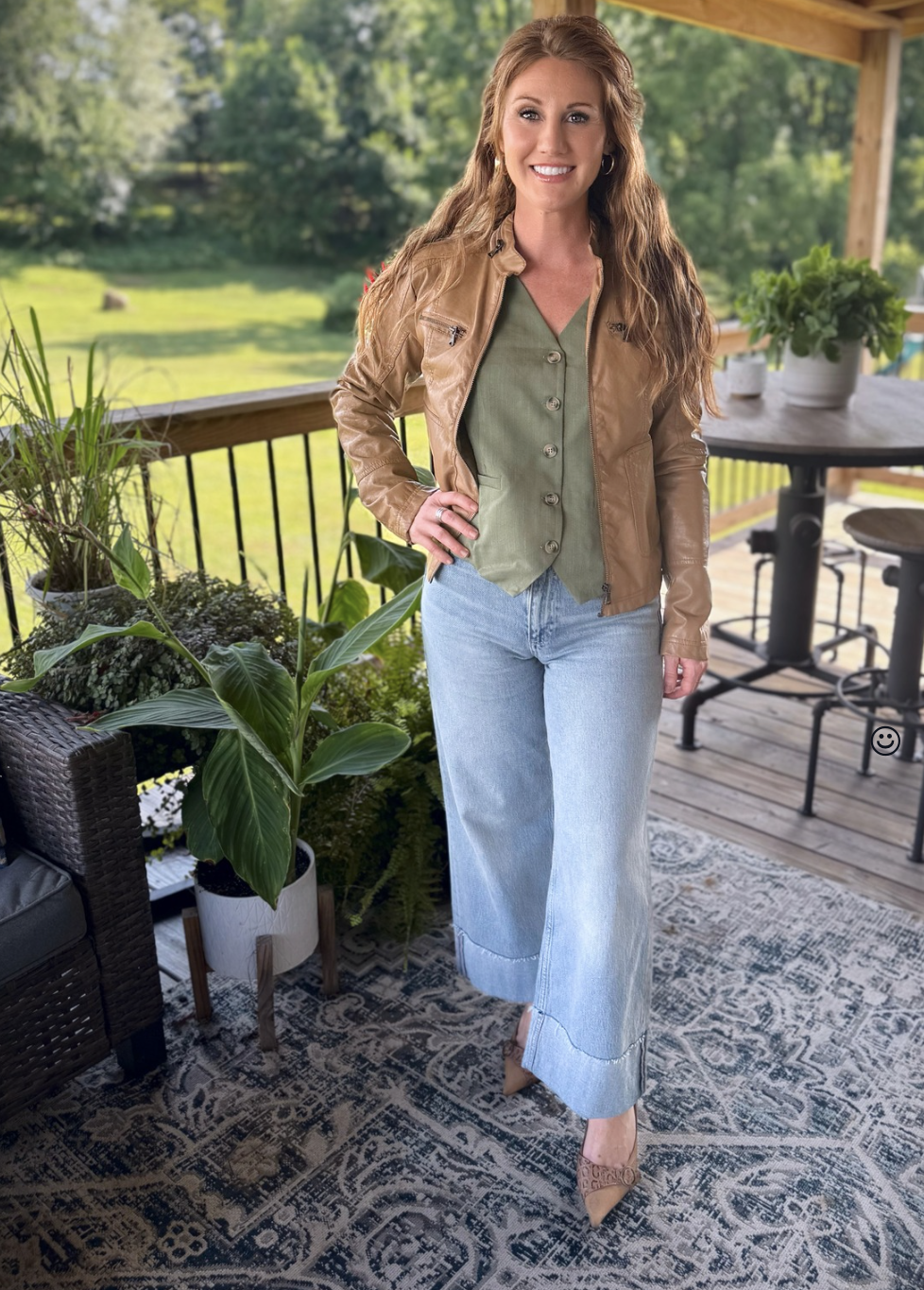 Stephanie, a petite 5'3" tall, wearing a olive green vest from Amazon with cuffed jeans and a jacket