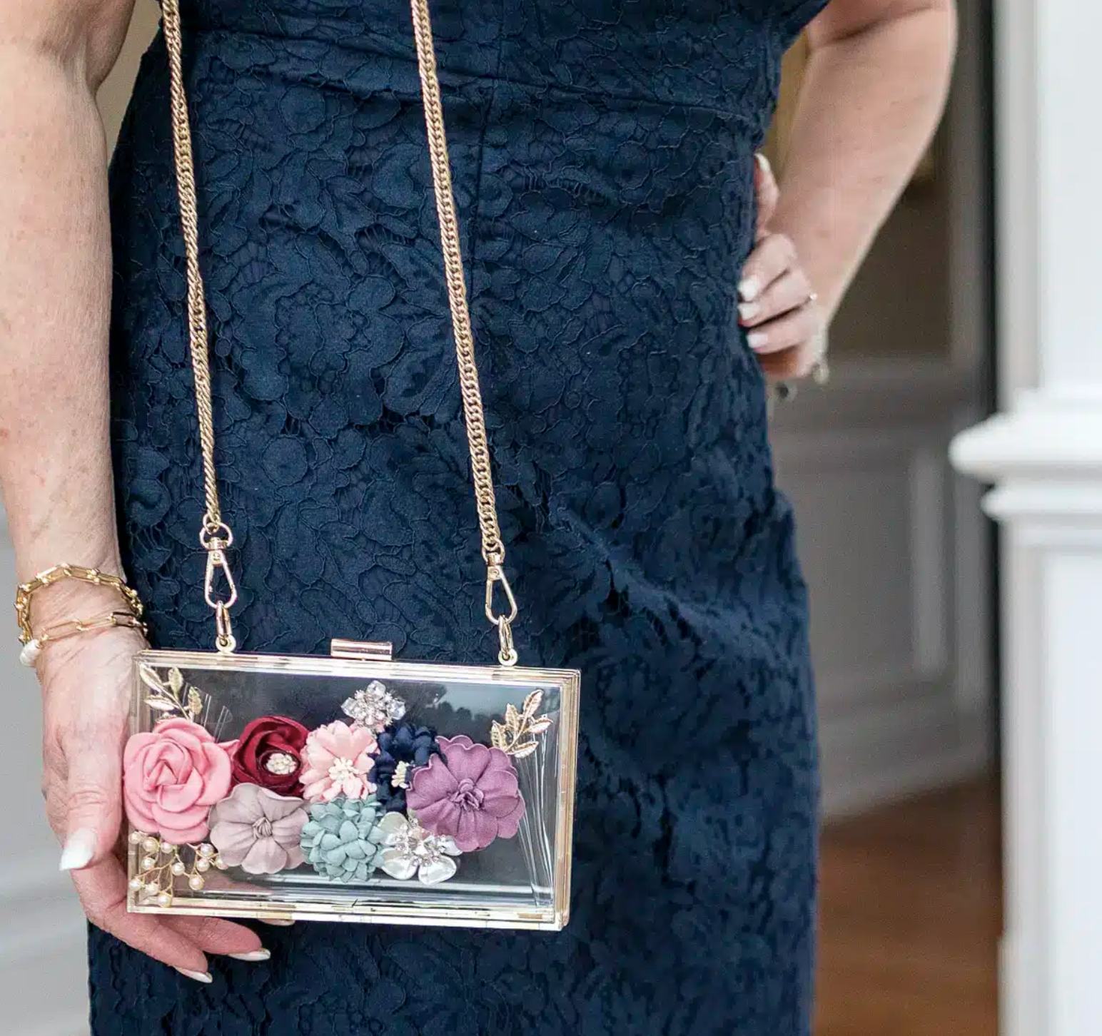 Navy lace dress with floral acrylic clutch