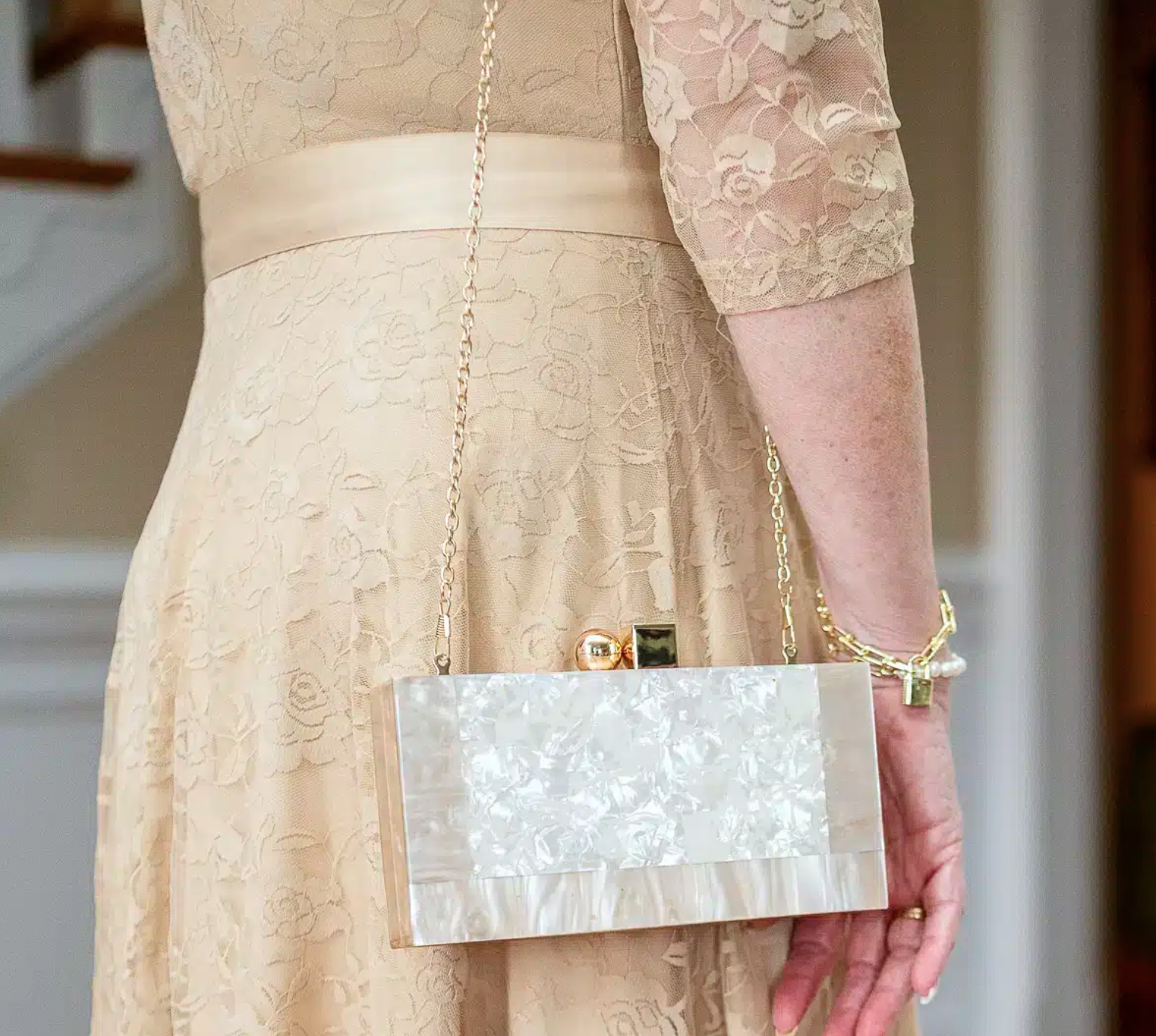Champagne lace dress with marble clutch