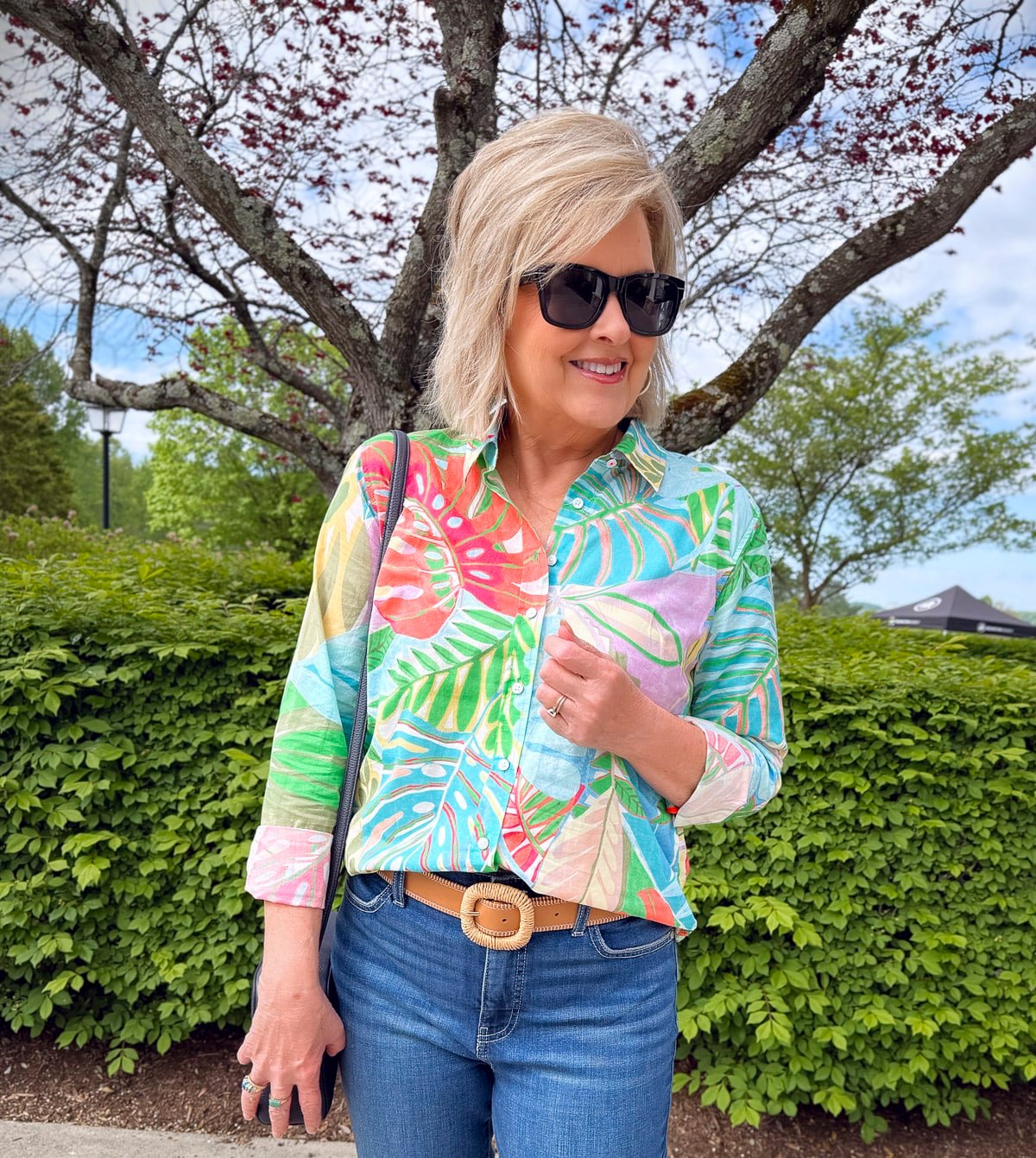 A WOMAN OVER 50 STYLING A COLORFUL PRINTED TOP WITH JEANS