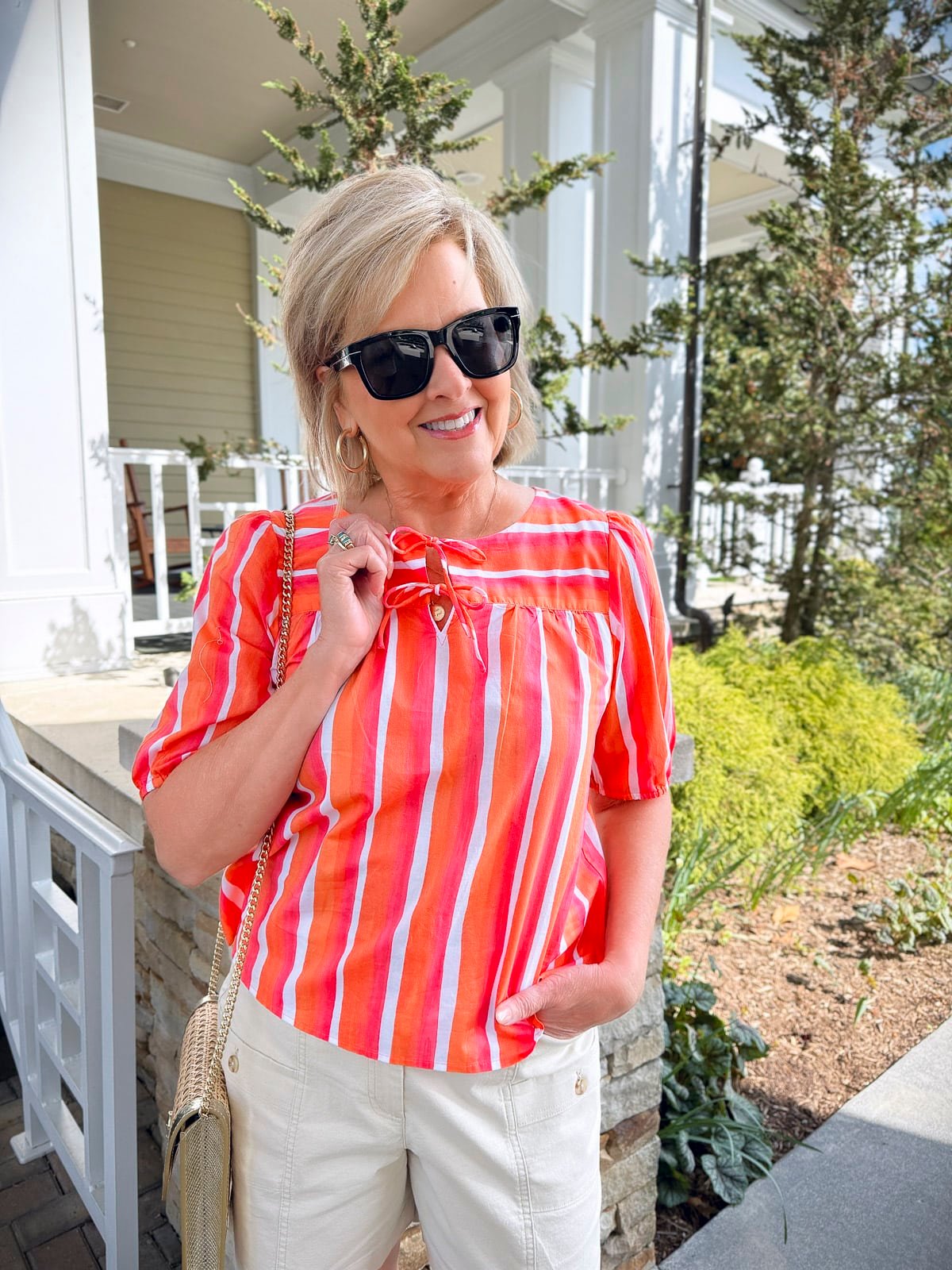 A WOMAN SHOWING HOW SHE IS WEARING BRIGHT NEON COLORS TO FLATTER HER SKIN TONE