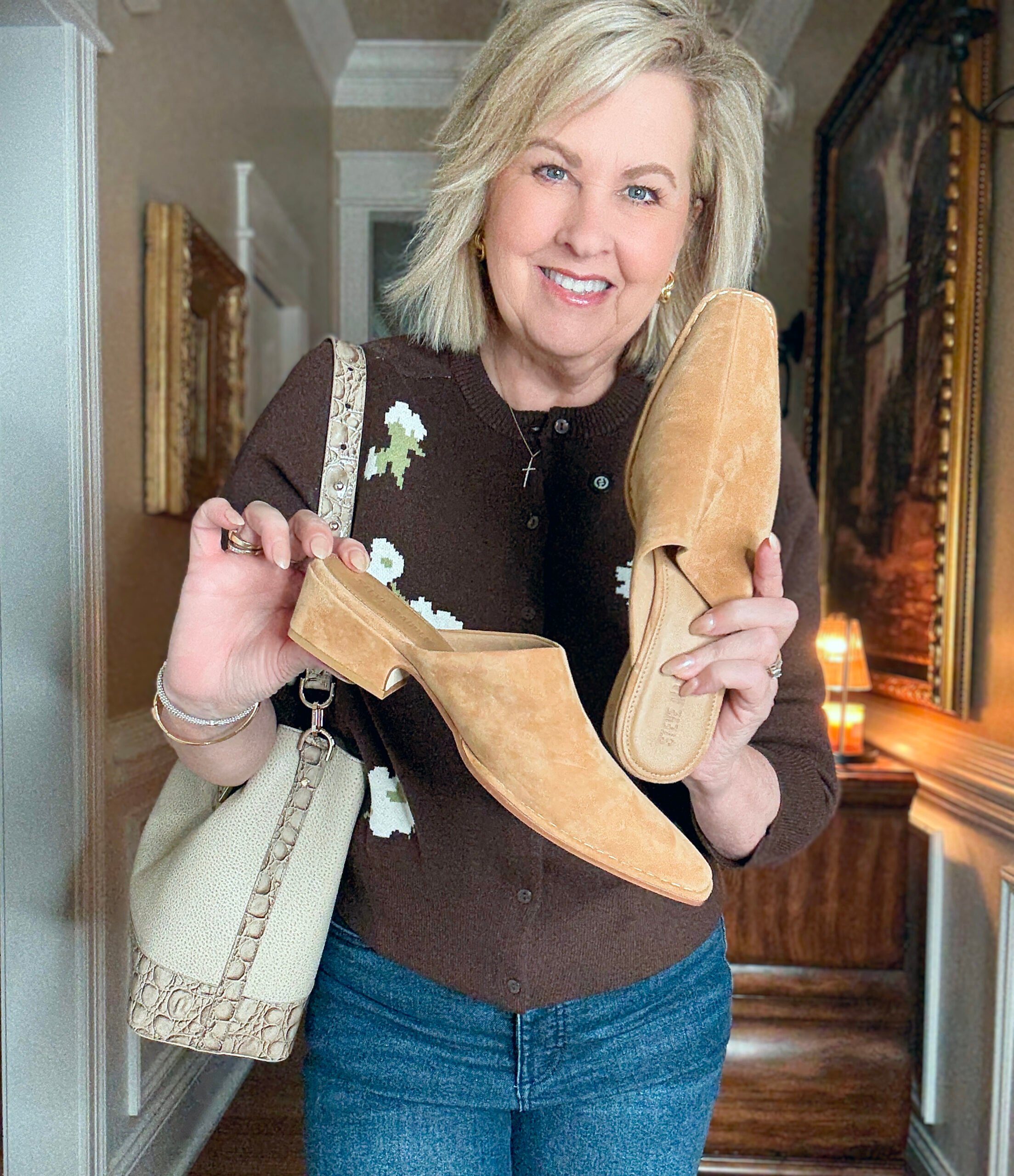 Tania holding mules with a Brahmin handbag