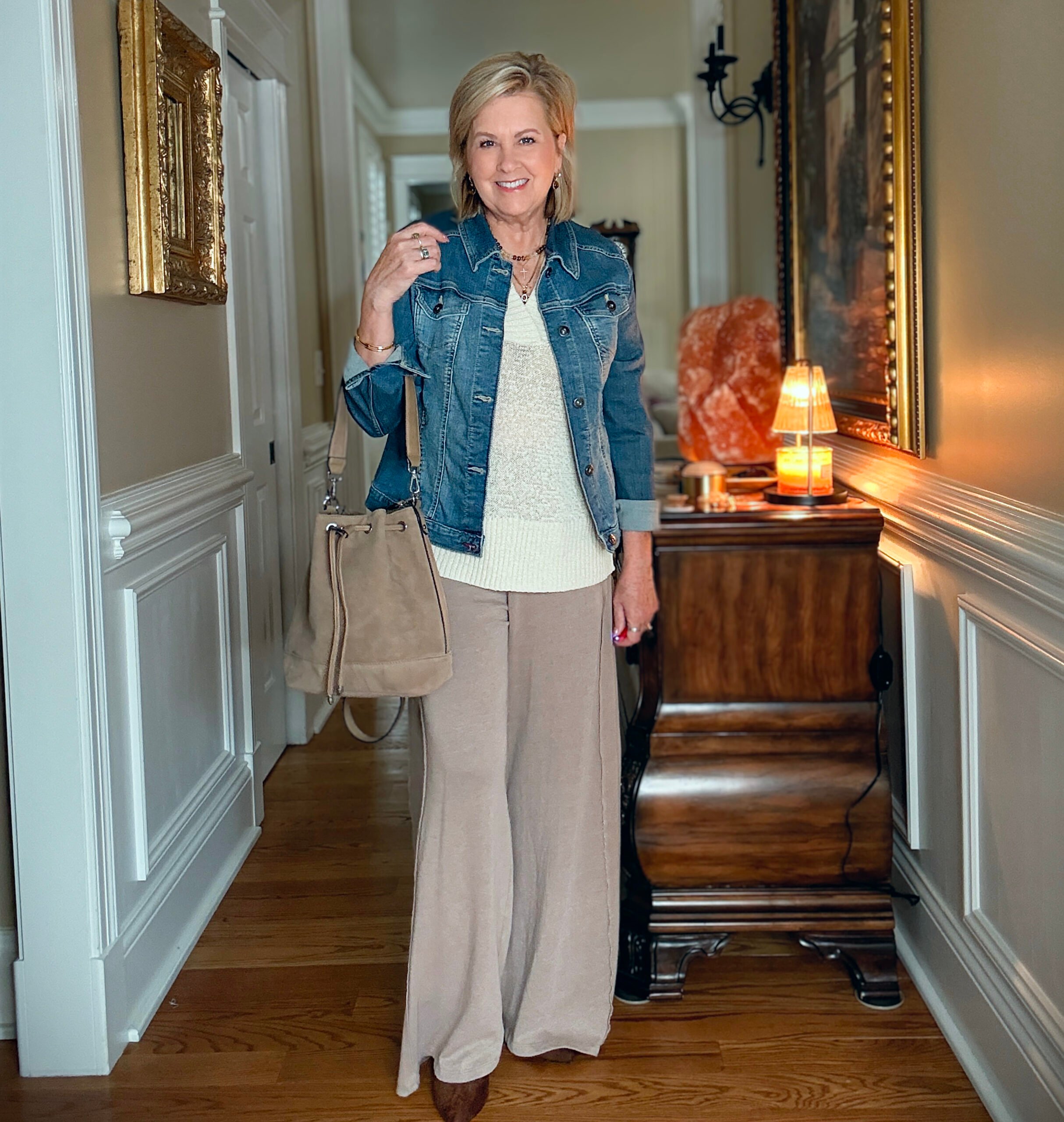 Tania is showing how to do a Summer to fall transition with jewelry, a denim jacket, boots, and a faux suede bag