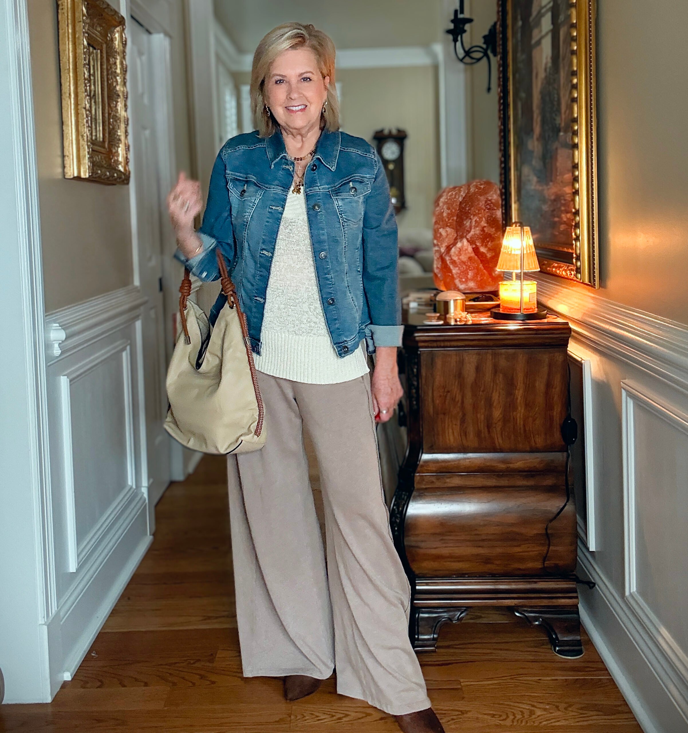 Tania is showing how to do a Summer to fall transition with jewelry, a denim jacket, boots, and a slouchy faux suede bag