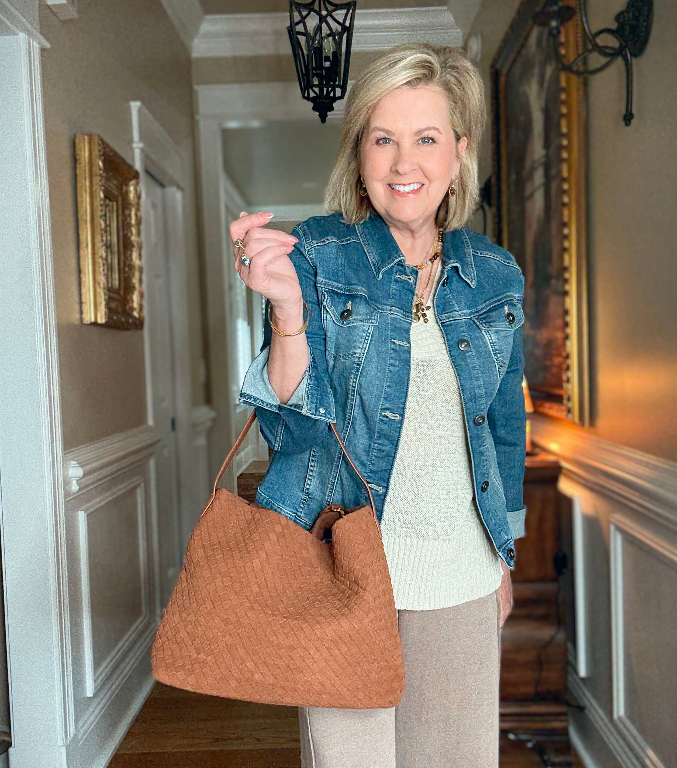 Tania is showing how to do a Summer to fall transition with jewelry, a denim jacket, and a woven faux suede bag