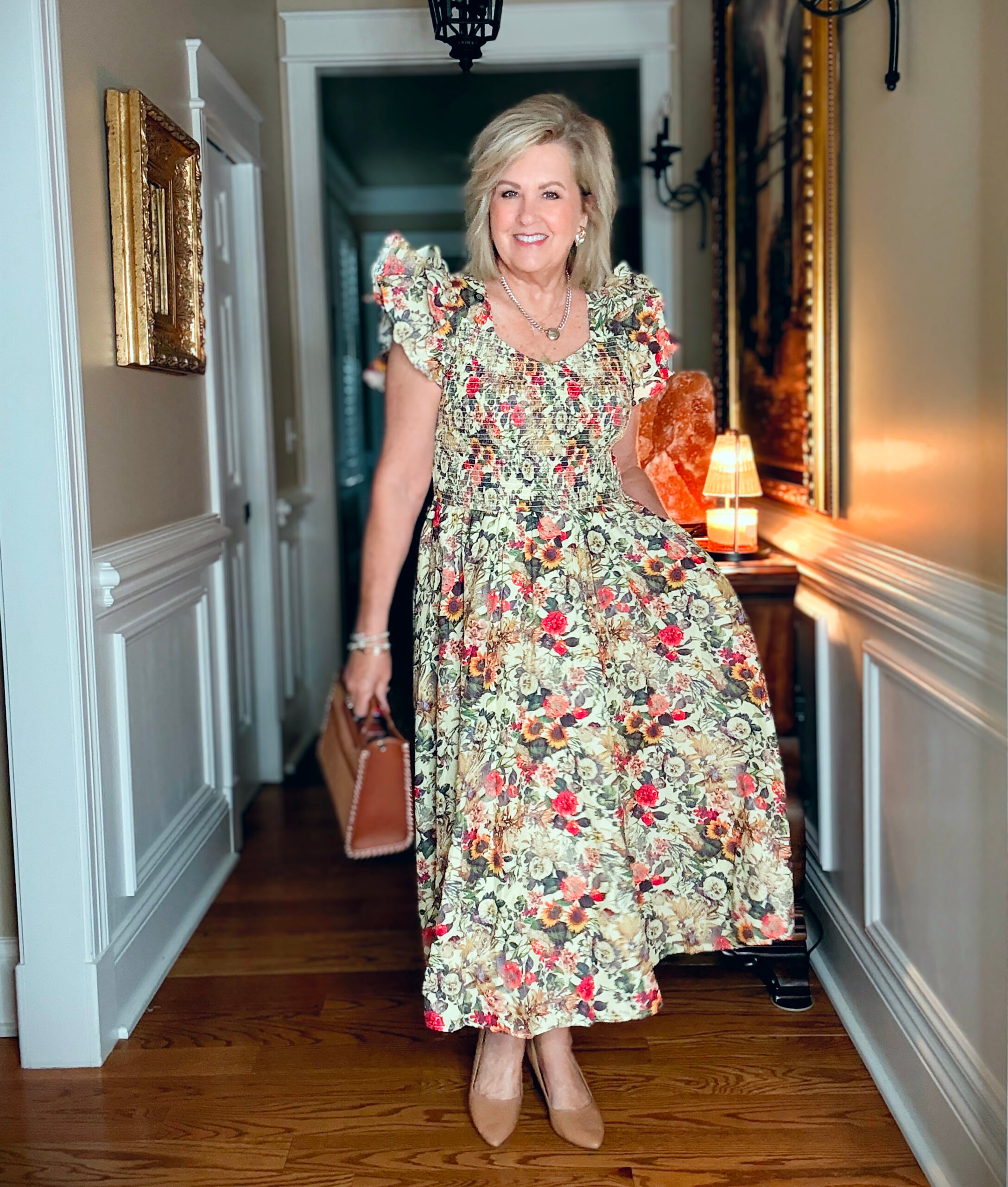 Tania Stephens is wearing a smocked floral dress with ruffle sleeves