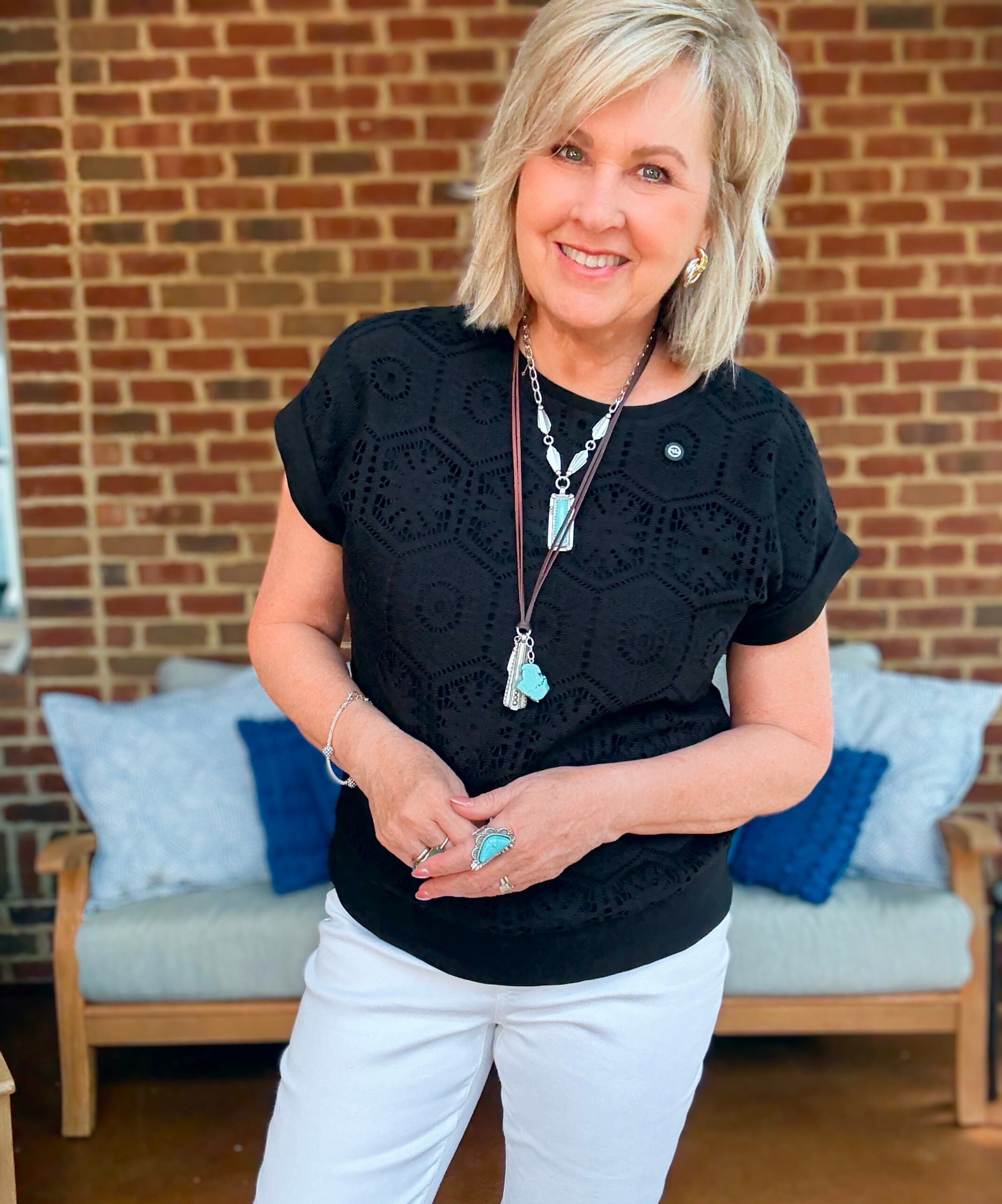 Tania Stephens wearing fall styles from Chico's - a black crochet top and turquoise necklace
