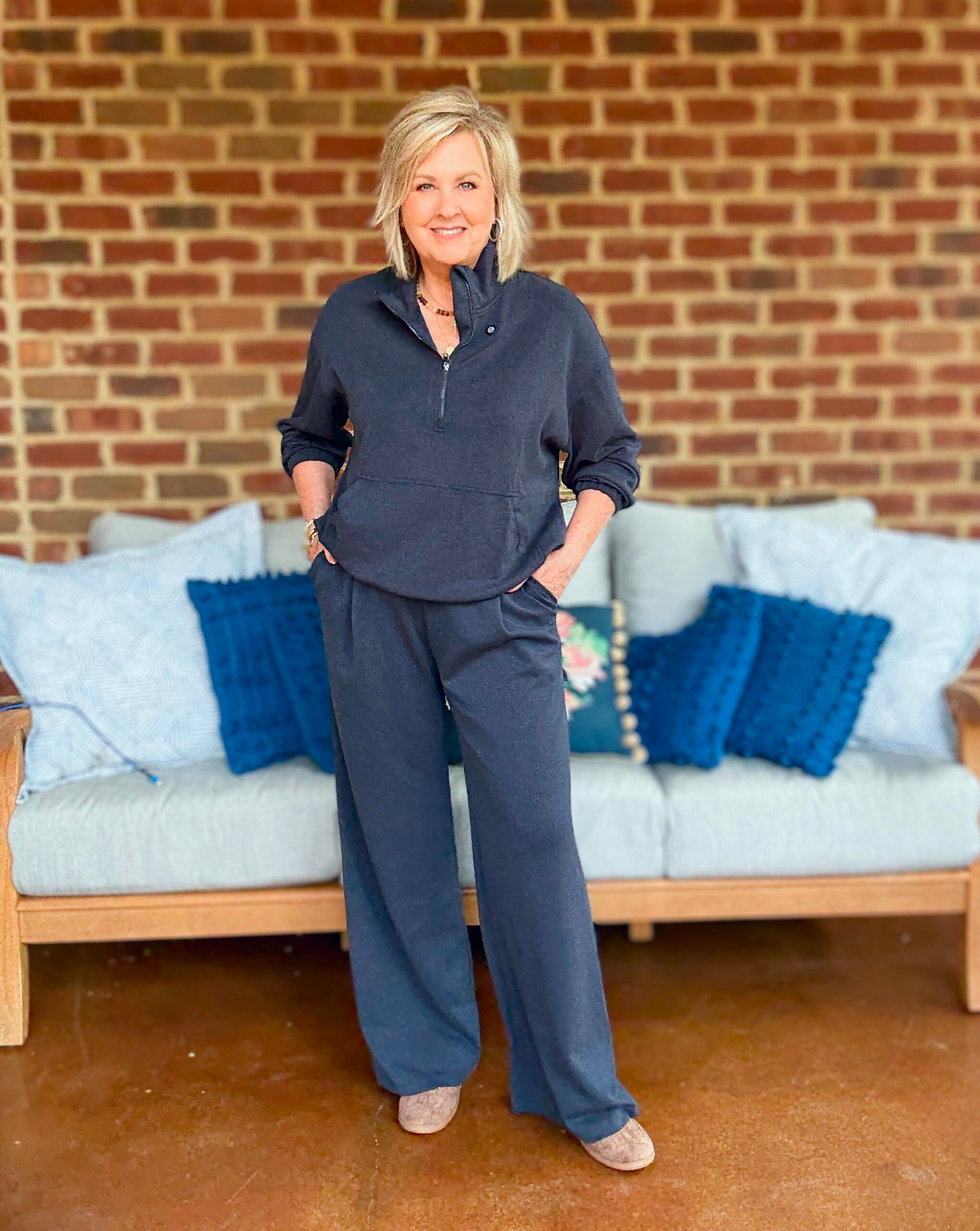 Tania wearing a navy cropped zip top and pull on pants
