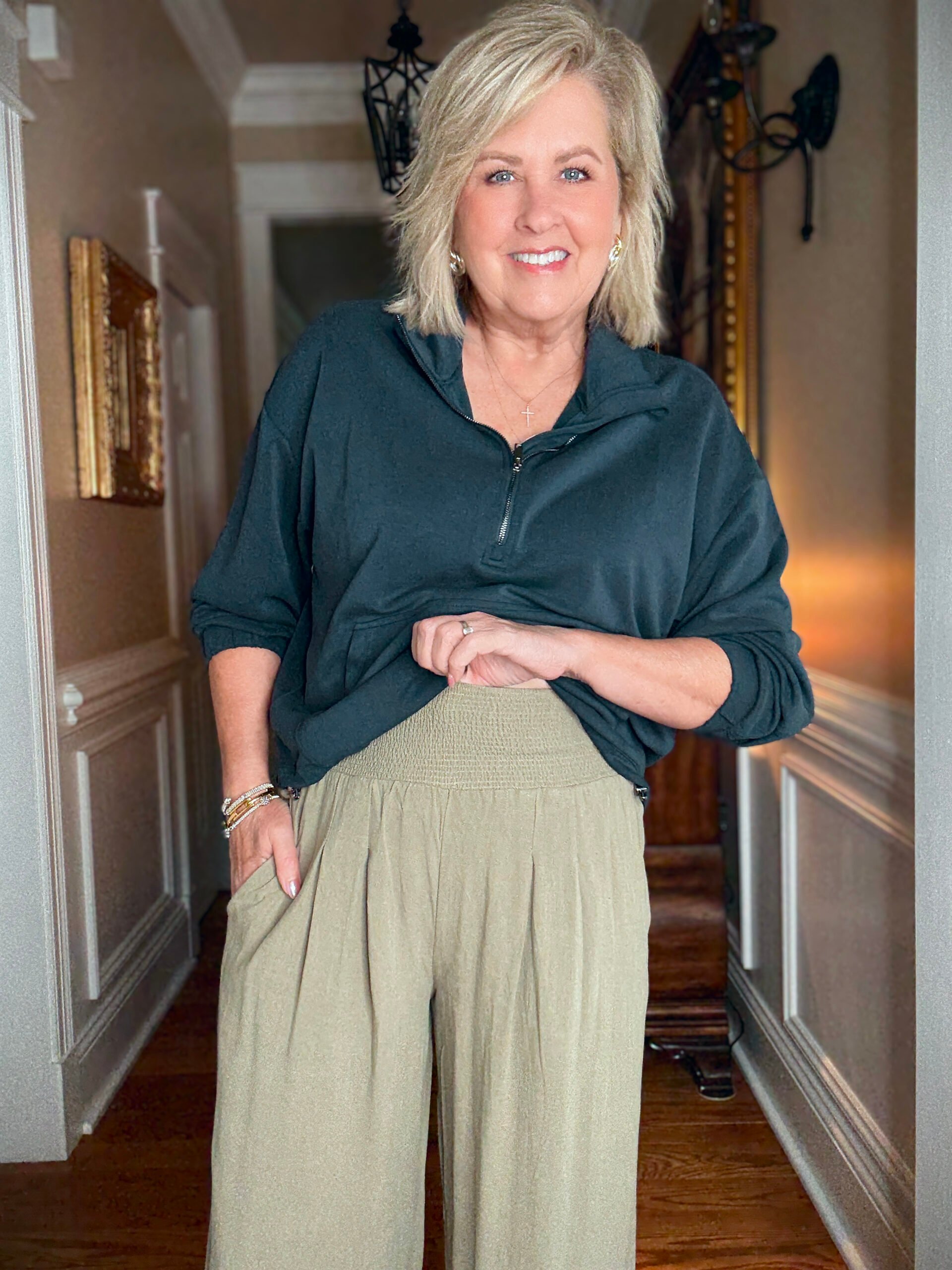 Tania wearing navy cropped zip top and pull on olive pants from Amazon