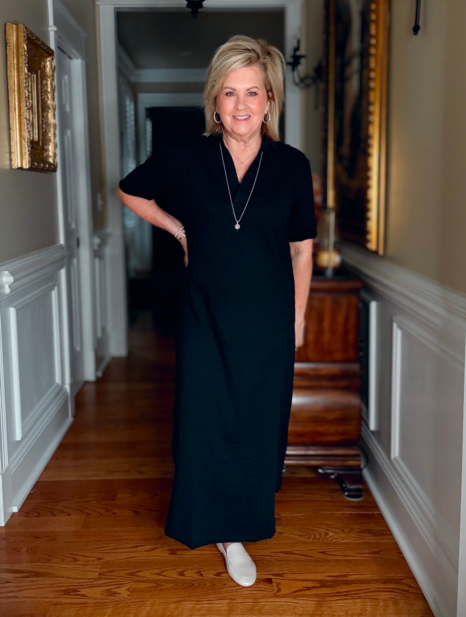 Tania wearing a black column polo dress from Frank & Eileen
