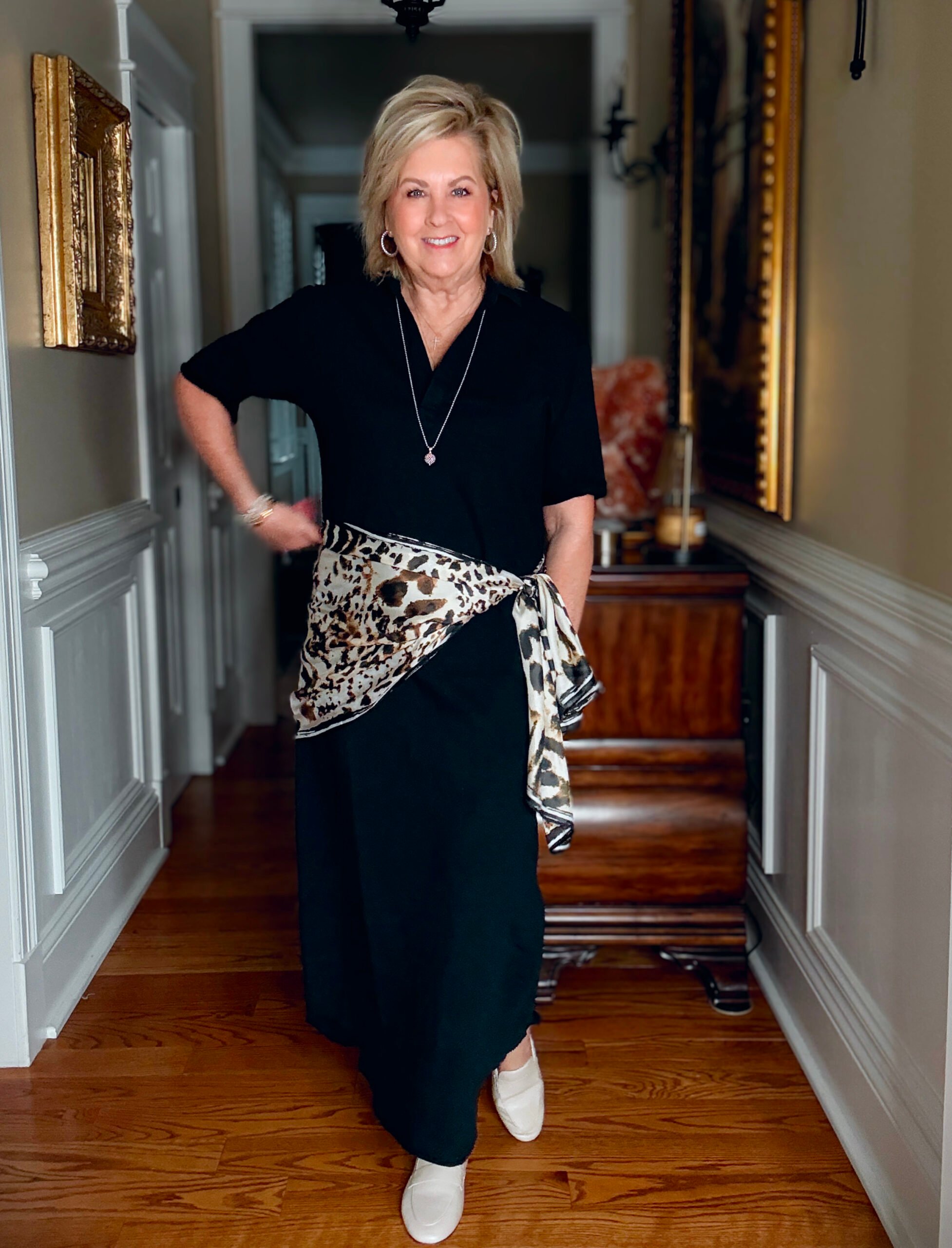 Tania wearing a black column polo dress from Frank & Eileen with a leopard print scarf